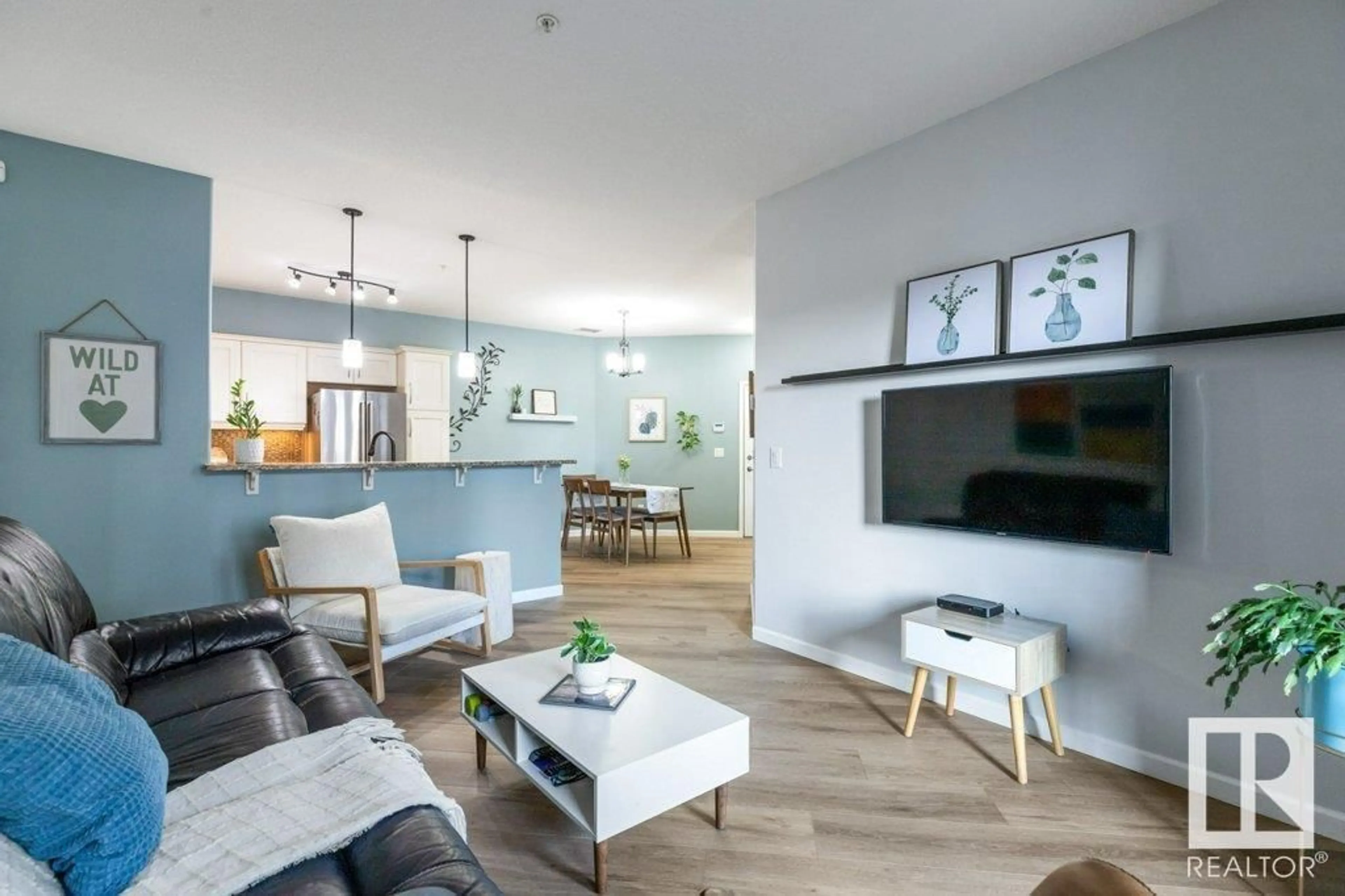 Living room with furniture, wood/laminate floor for 6083 - 119 MAYNARD WY, Edmonton Alberta T6R0S5