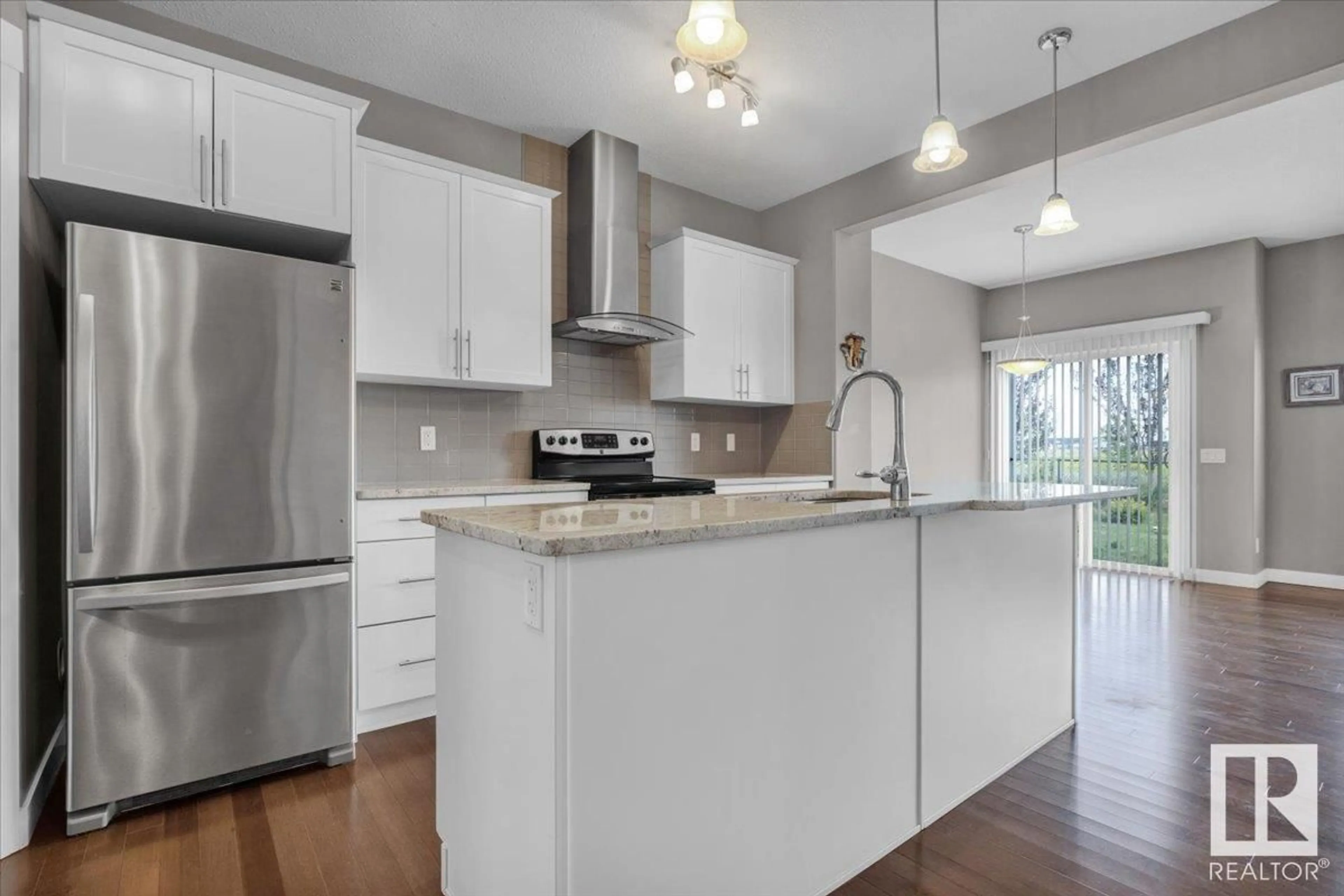 Open concept kitchen, wood/laminate floor for NW - 7214 174 AV, Edmonton Alberta T5Z0L3