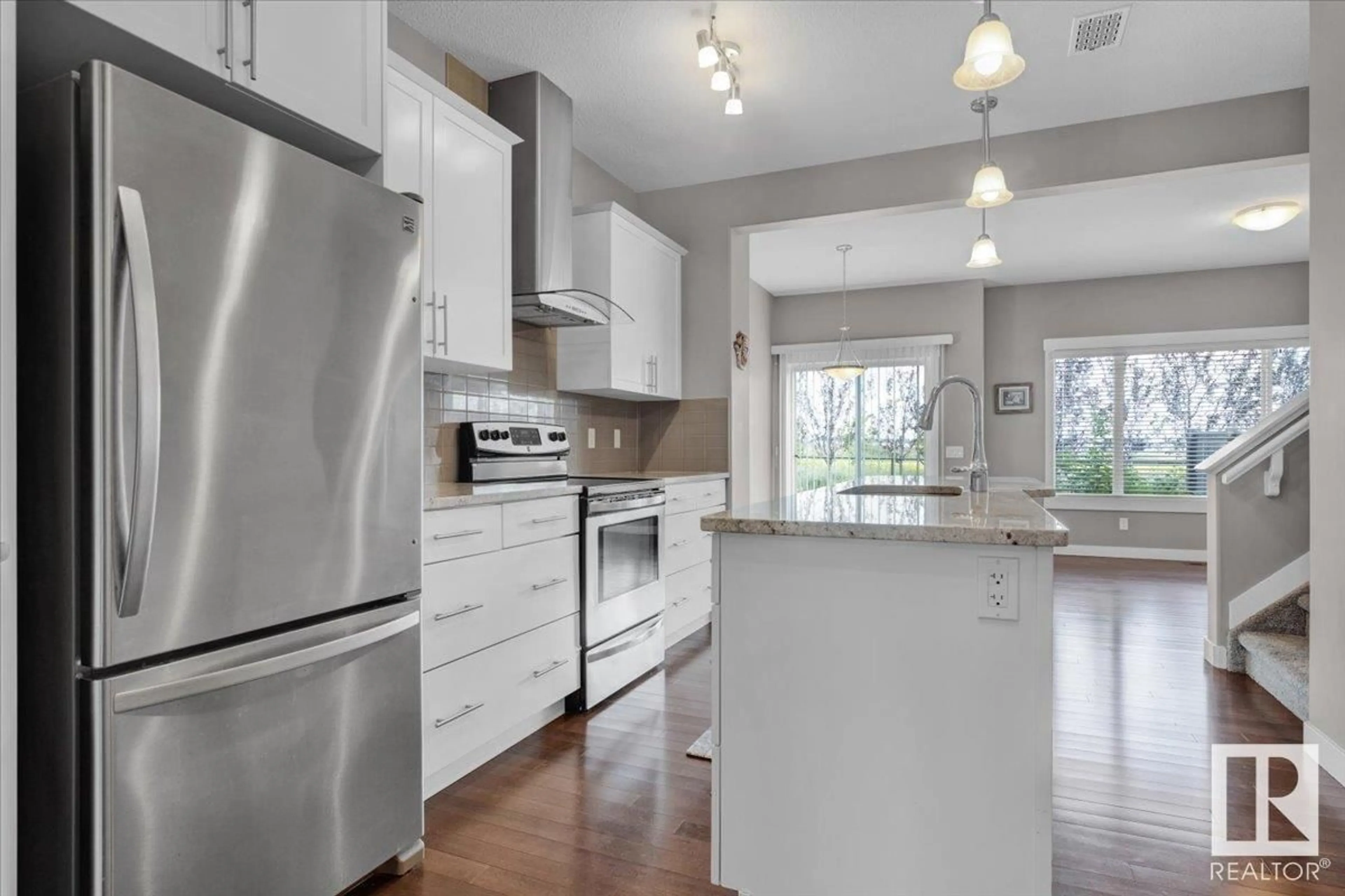 Open concept kitchen, wood/laminate floor for NW - 7214 174 AV, Edmonton Alberta T5Z0L3