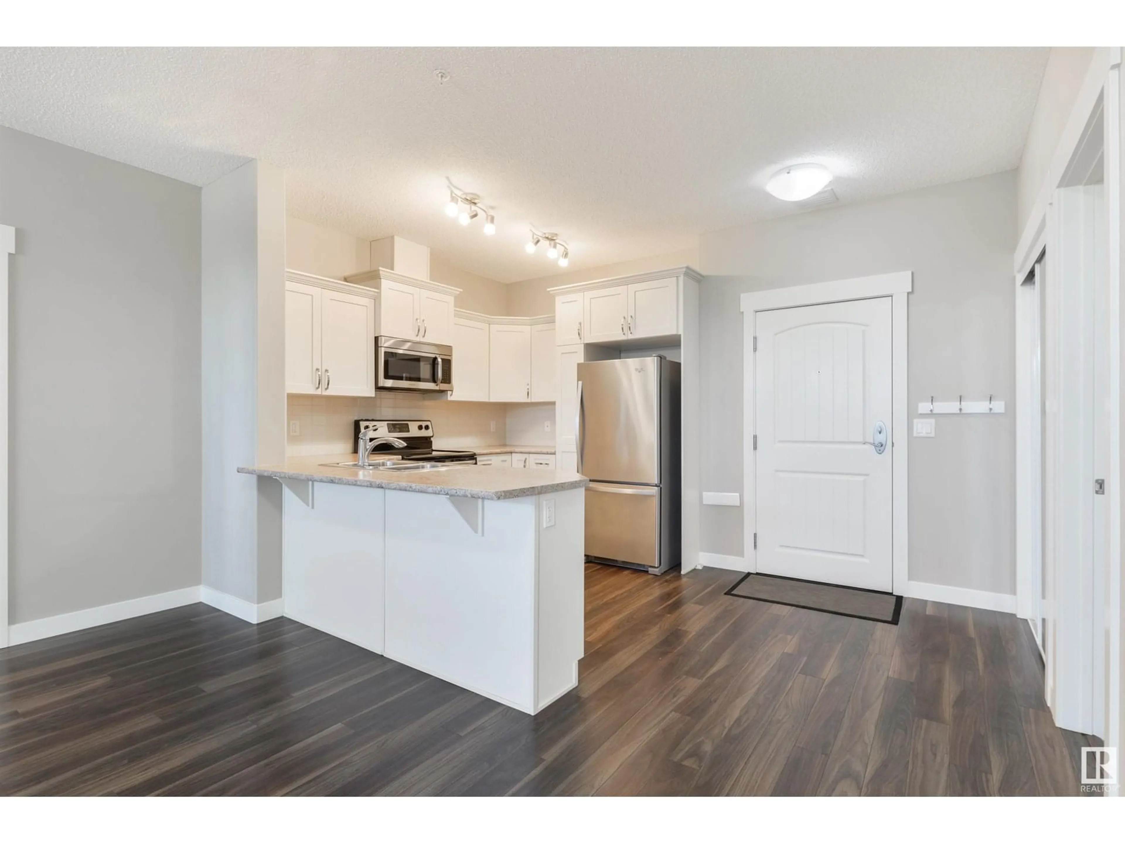 Open concept kitchen, wood/laminate floor for 206 - 511 QUEEN ST, Spruce Grove Alberta T7X0G4
