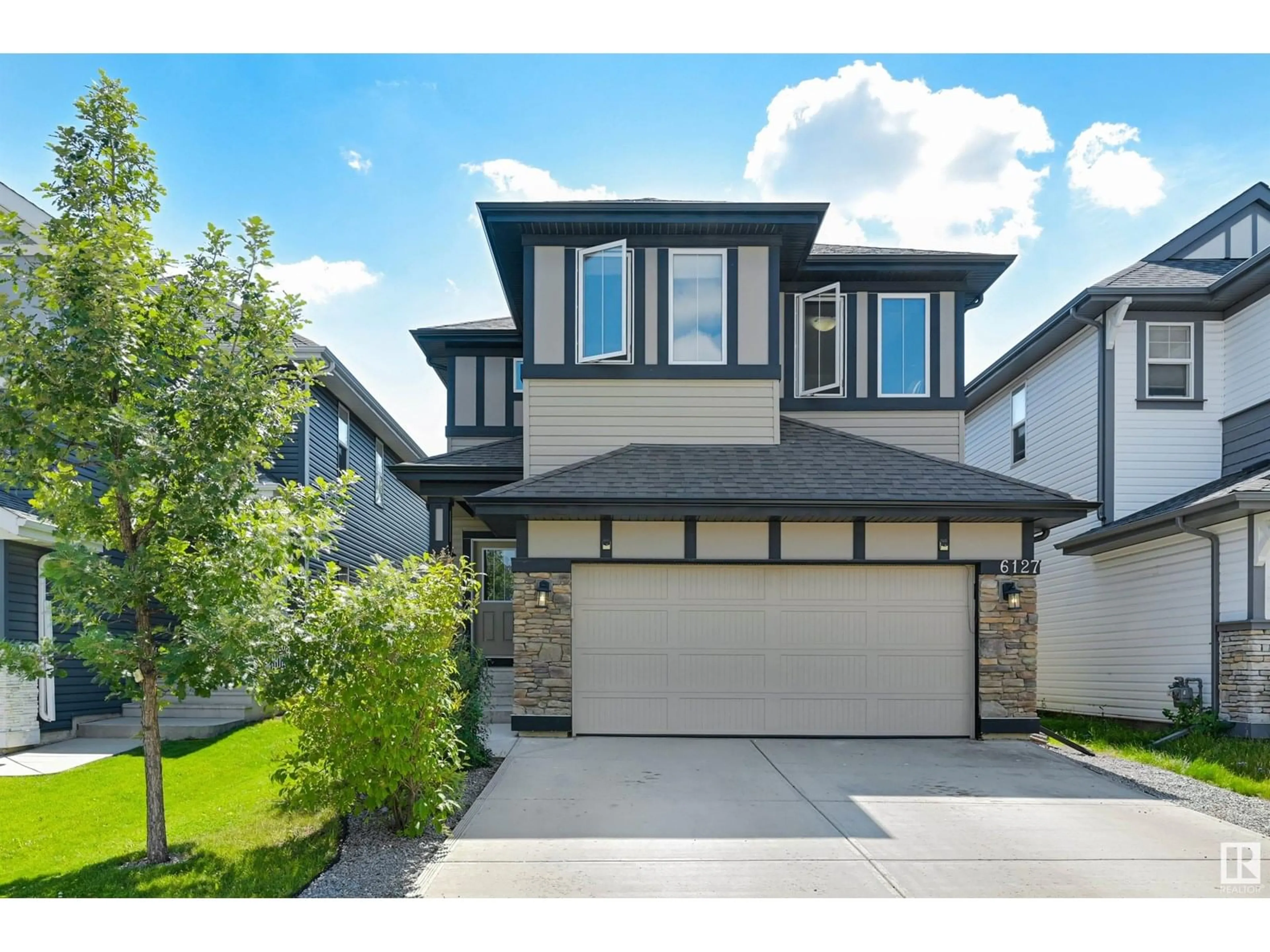 Home with vinyl exterior material, street for 6127 175 AV, Edmonton Alberta T5Y3N7