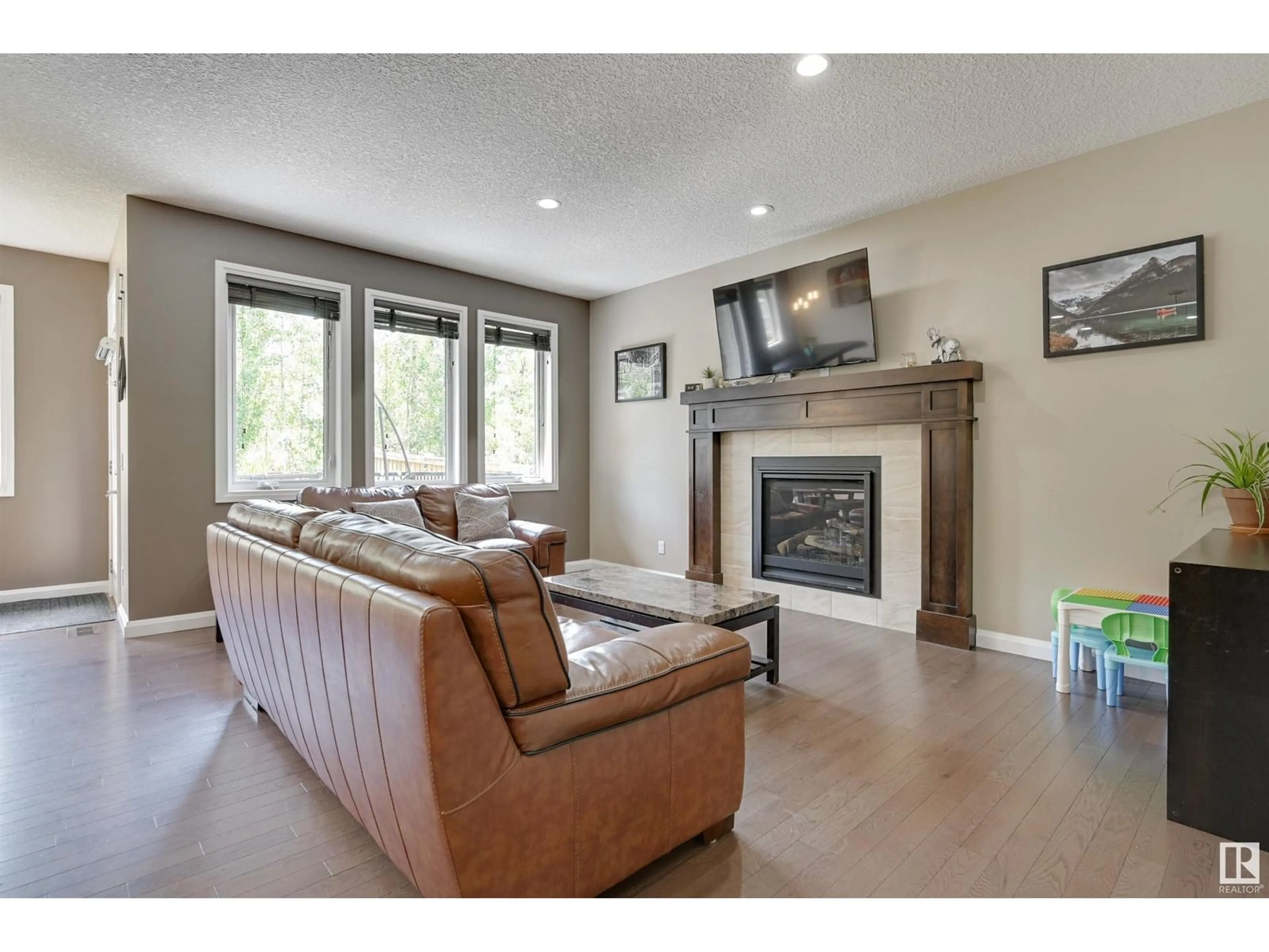 Living room with furniture, wood/laminate floor for 6127 175 AV, Edmonton Alberta T5Y3N7