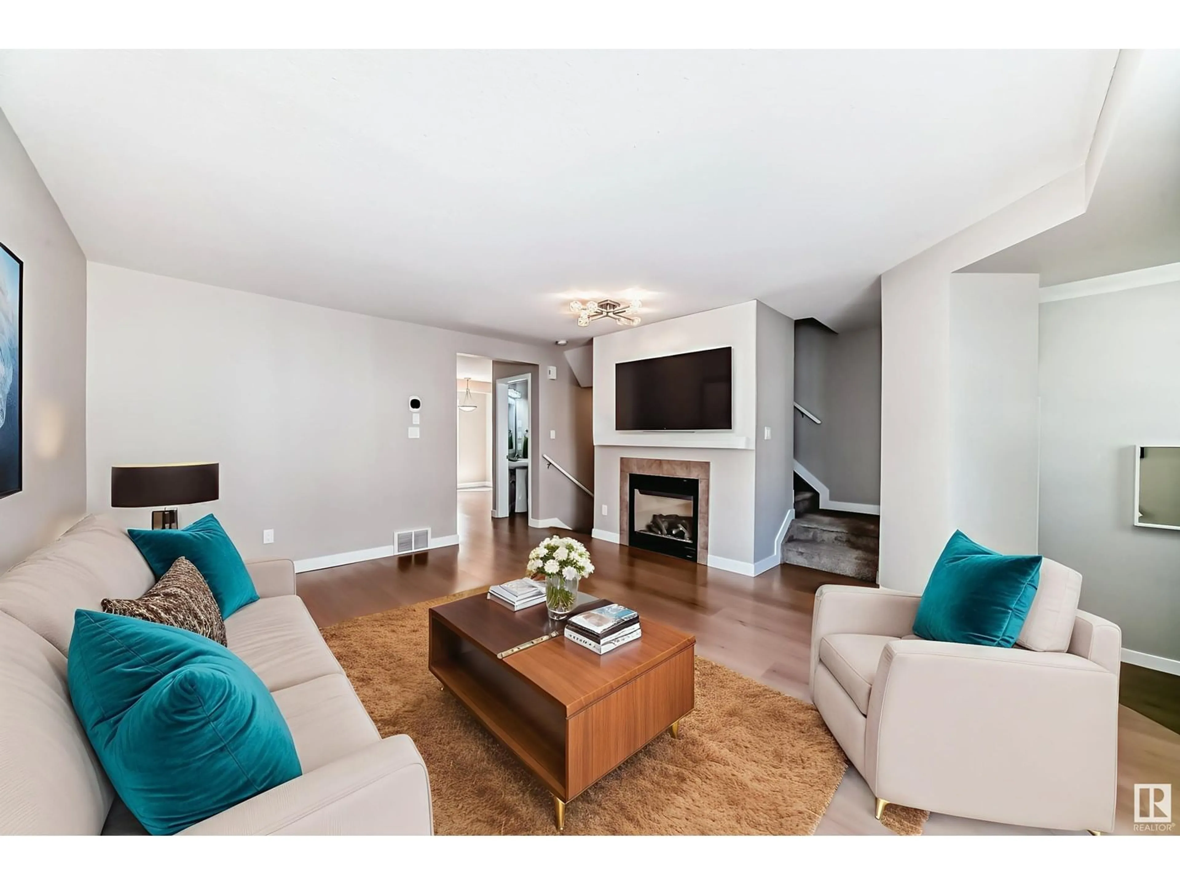 Living room with furniture, wood/laminate floor for 311 178 BRIDGEPORT BV, Leduc Alberta T9E8S8