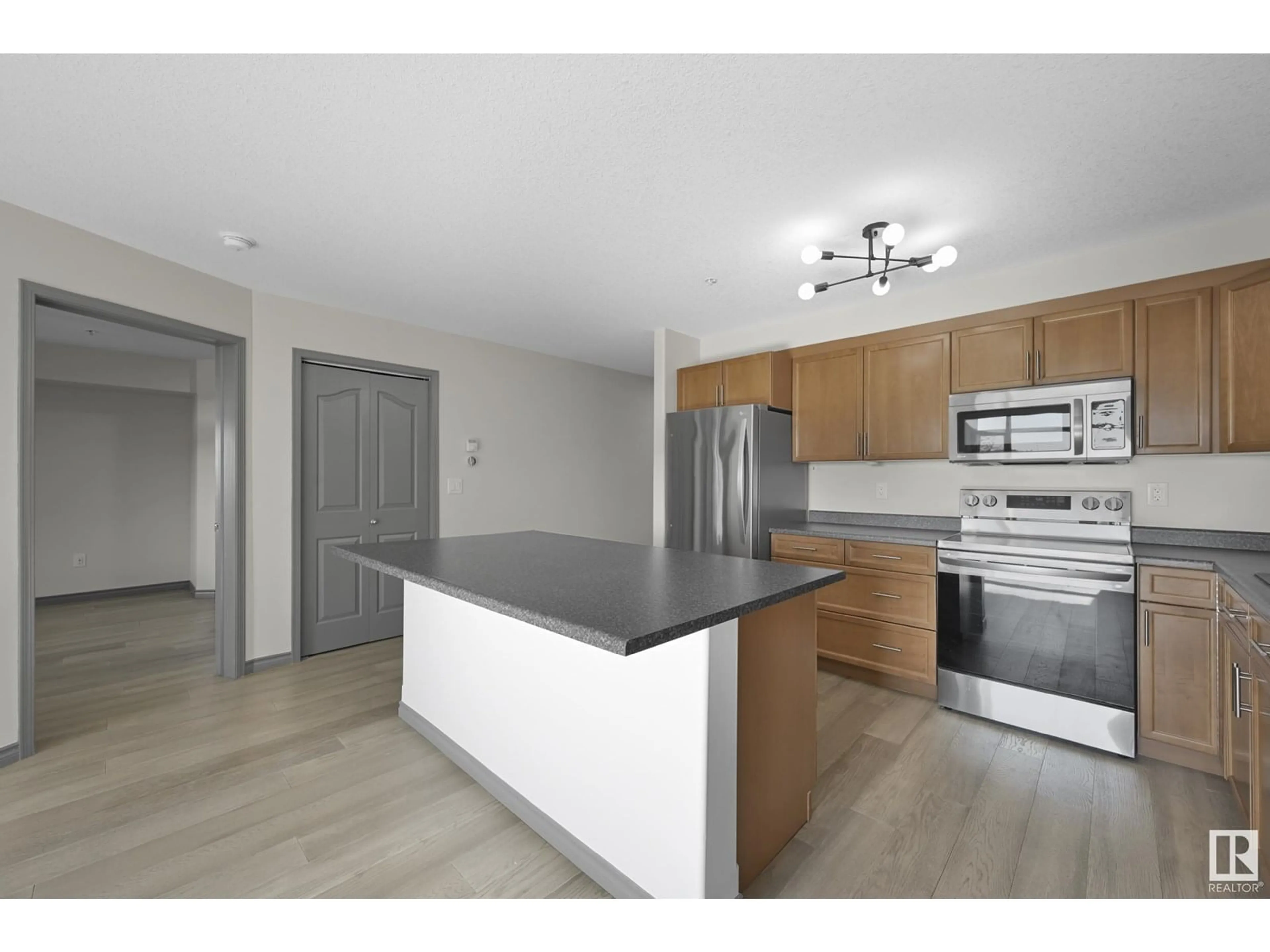 Open concept kitchen, wood/laminate floor for 216 - 1589 GLASTONBURY BV, Edmonton Alberta T5T2V1