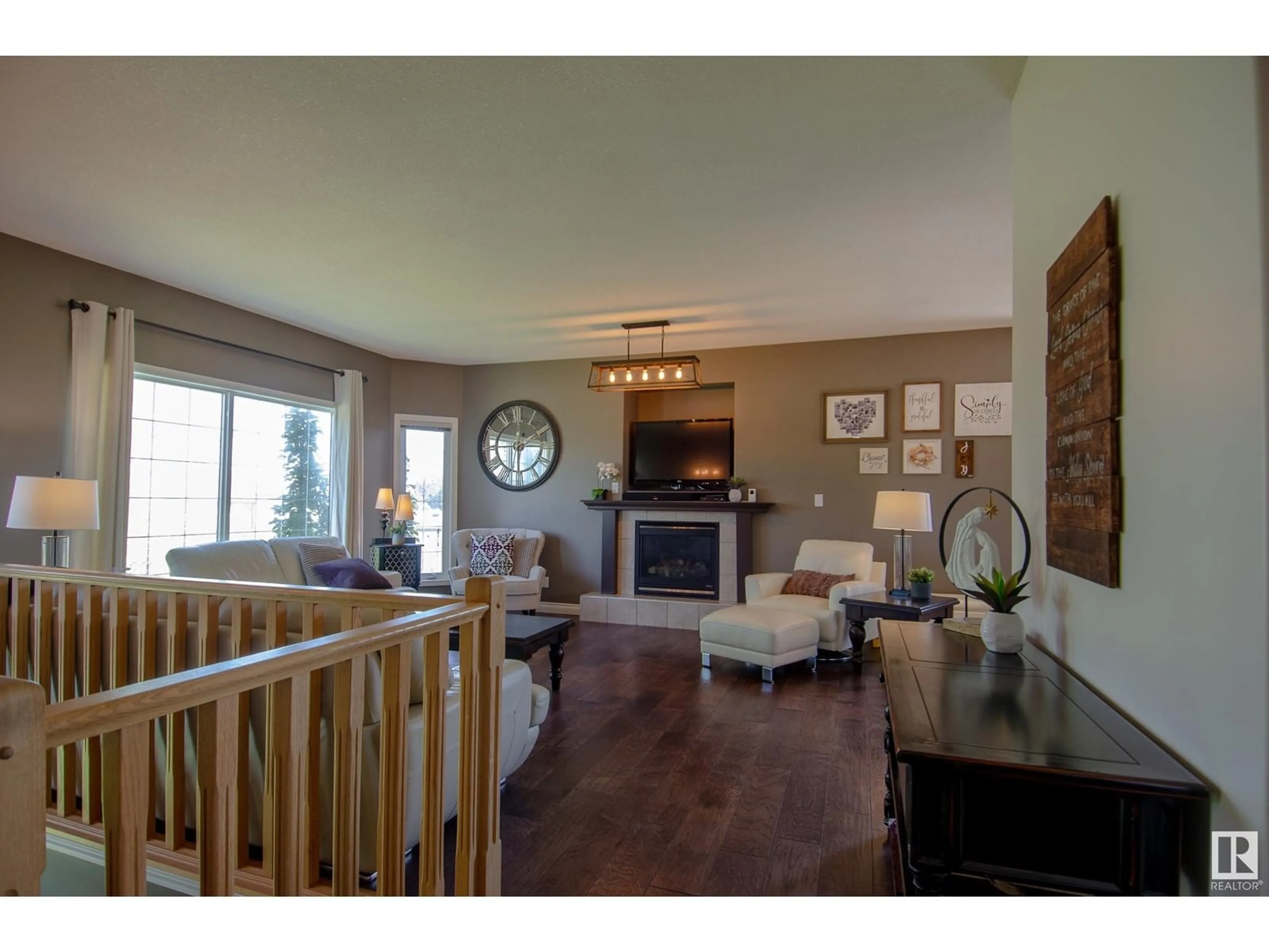 Living room with furniture, wood/laminate floor for 53522 - 42 RGE ROAD 272, Rural Parkland County Alberta T7X3N2