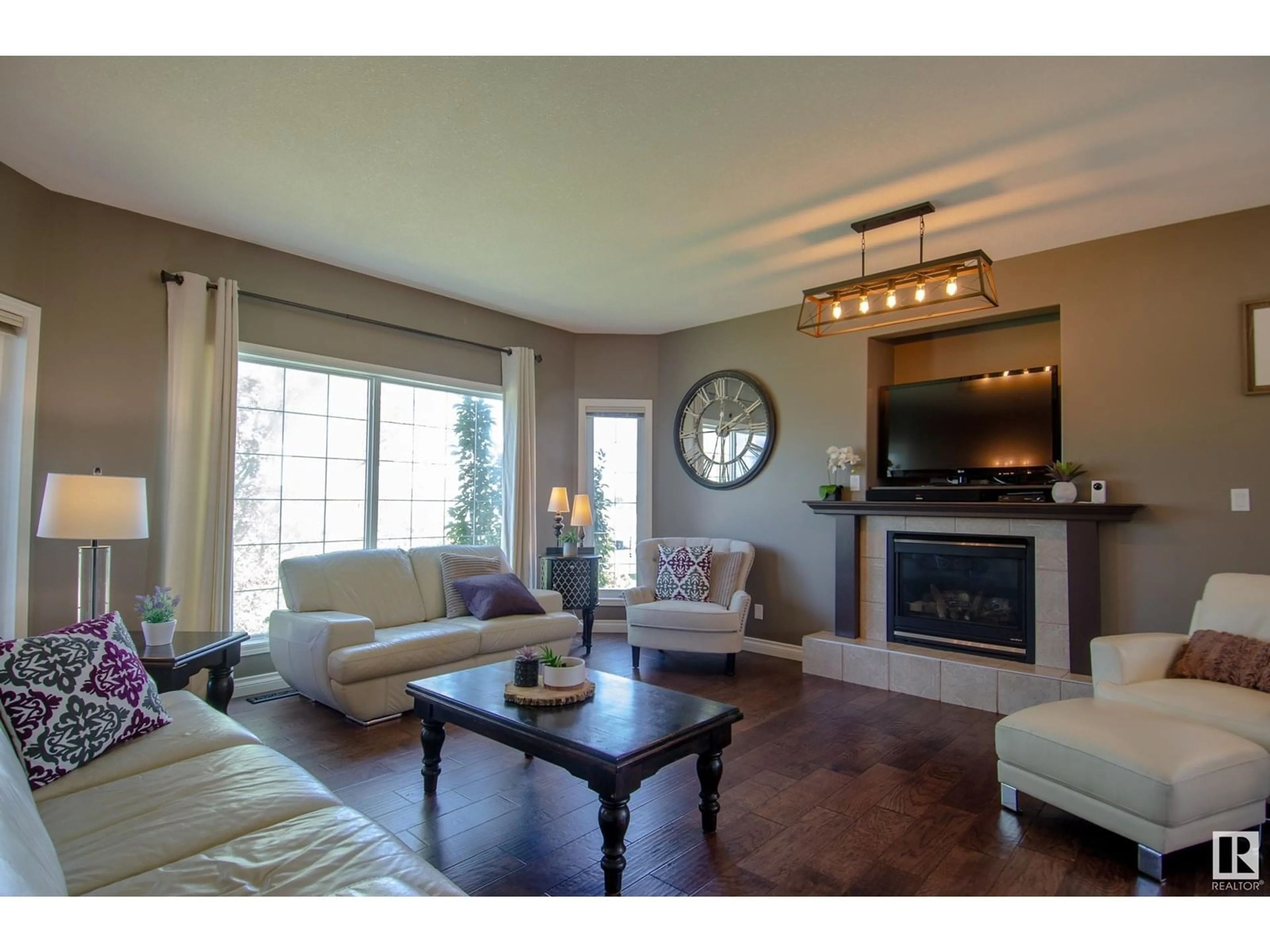 Living room with furniture, wood/laminate floor for 53522 - 42 RGE ROAD 272, Rural Parkland County Alberta T7X3N2