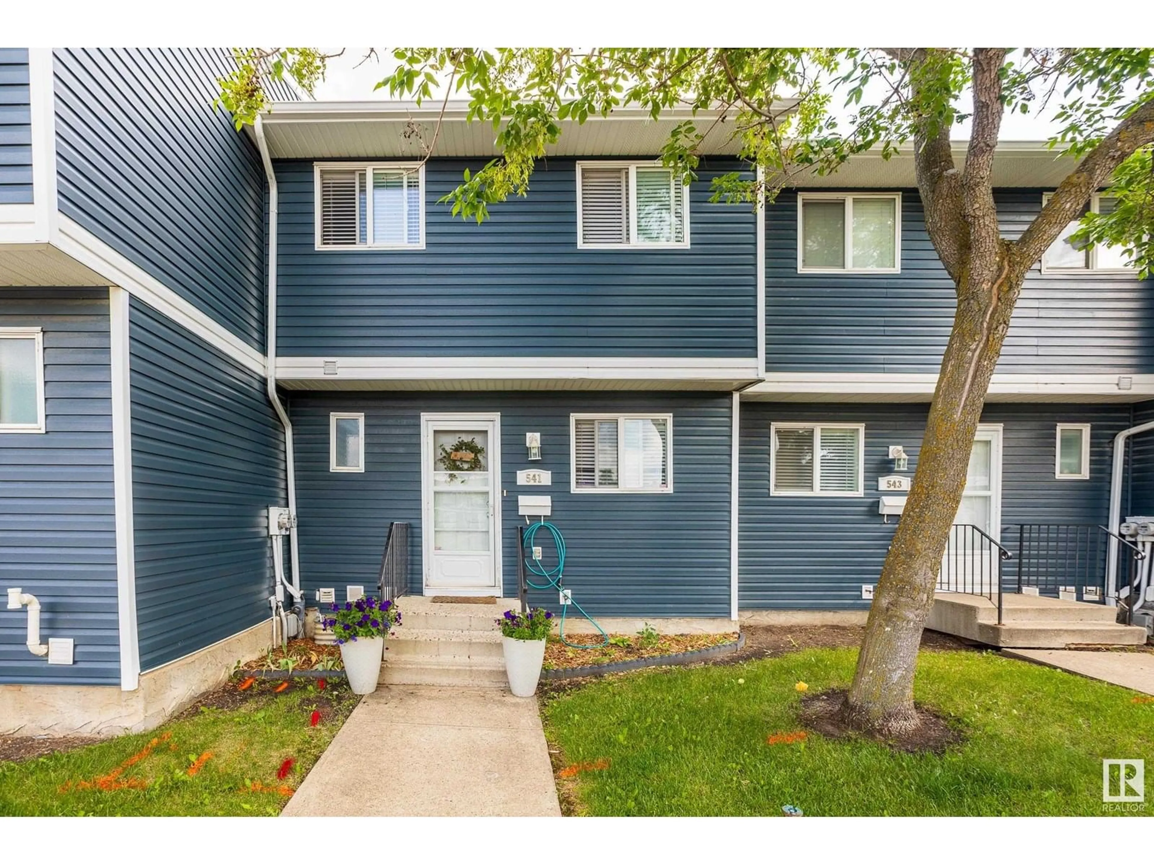 Home with vinyl exterior material, street for 541 DUNLUCE RD, Edmonton Alberta T5X4P4