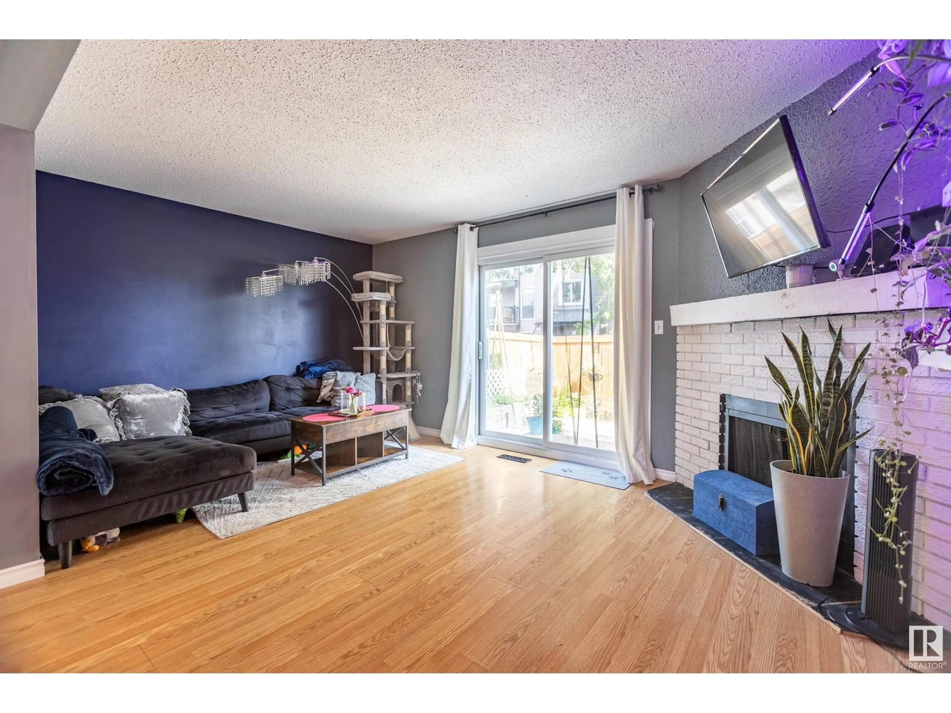 Living room with furniture, wood/laminate floor for 541 DUNLUCE RD, Edmonton Alberta T5X4P4
