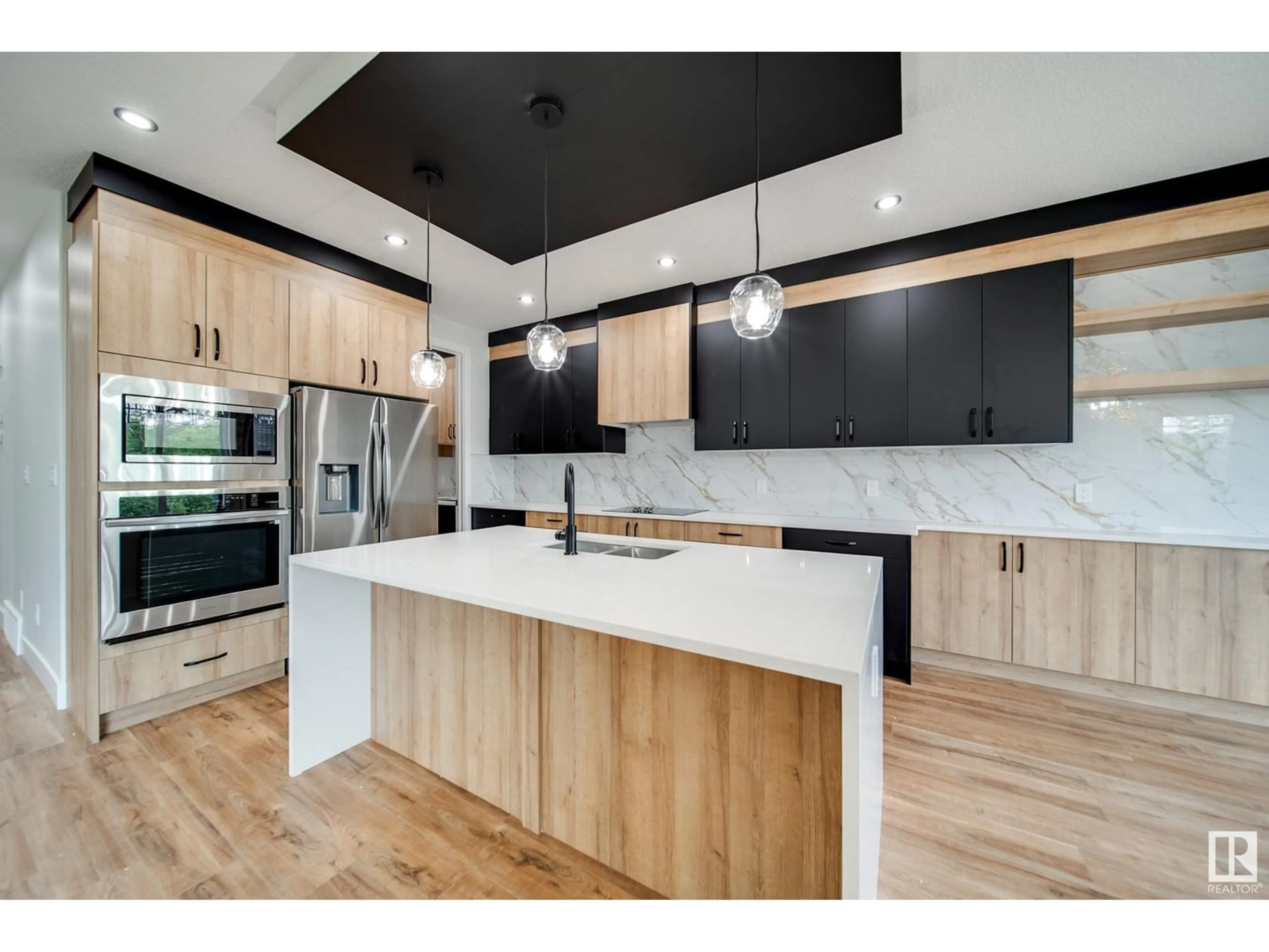 Open concept kitchen, wood/laminate floor for 8812 183 AV, Edmonton Alberta T5Z0S8