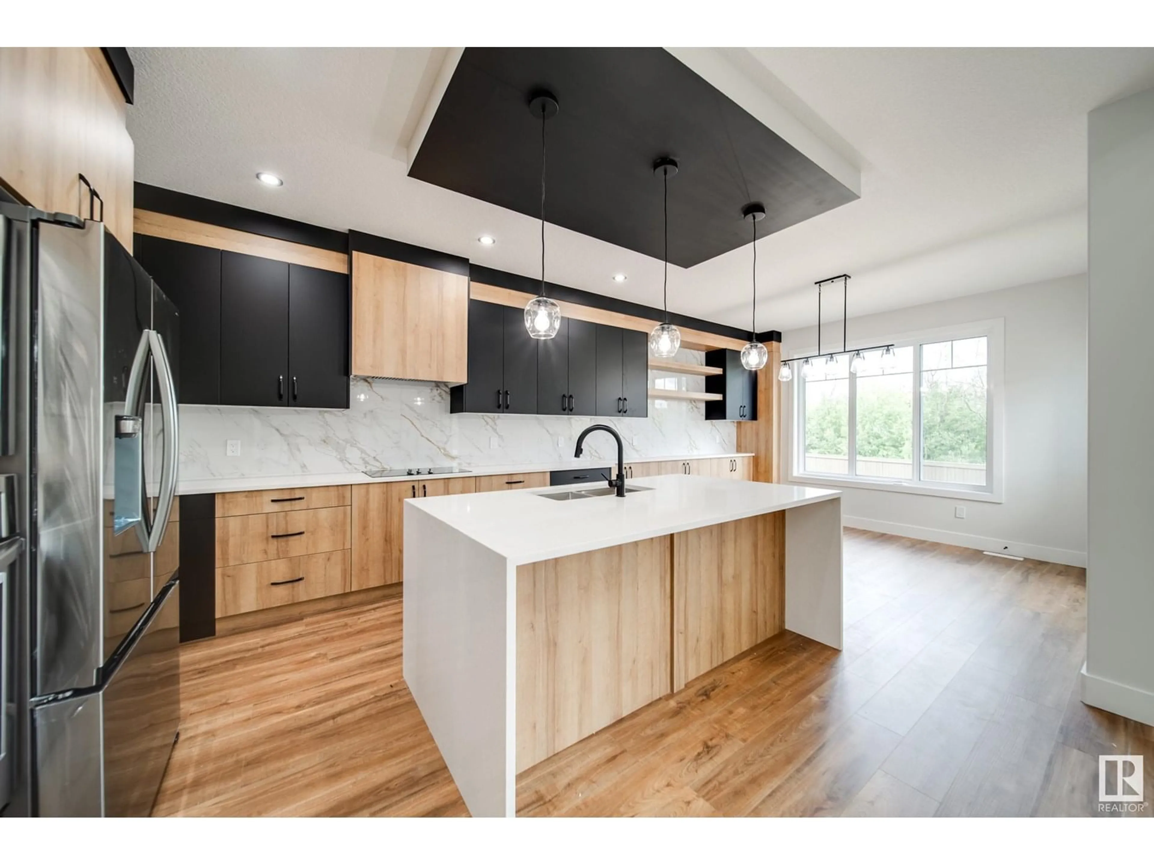 Open concept kitchen, wood/laminate floor for 8812 183 AV, Edmonton Alberta T5Z0S8
