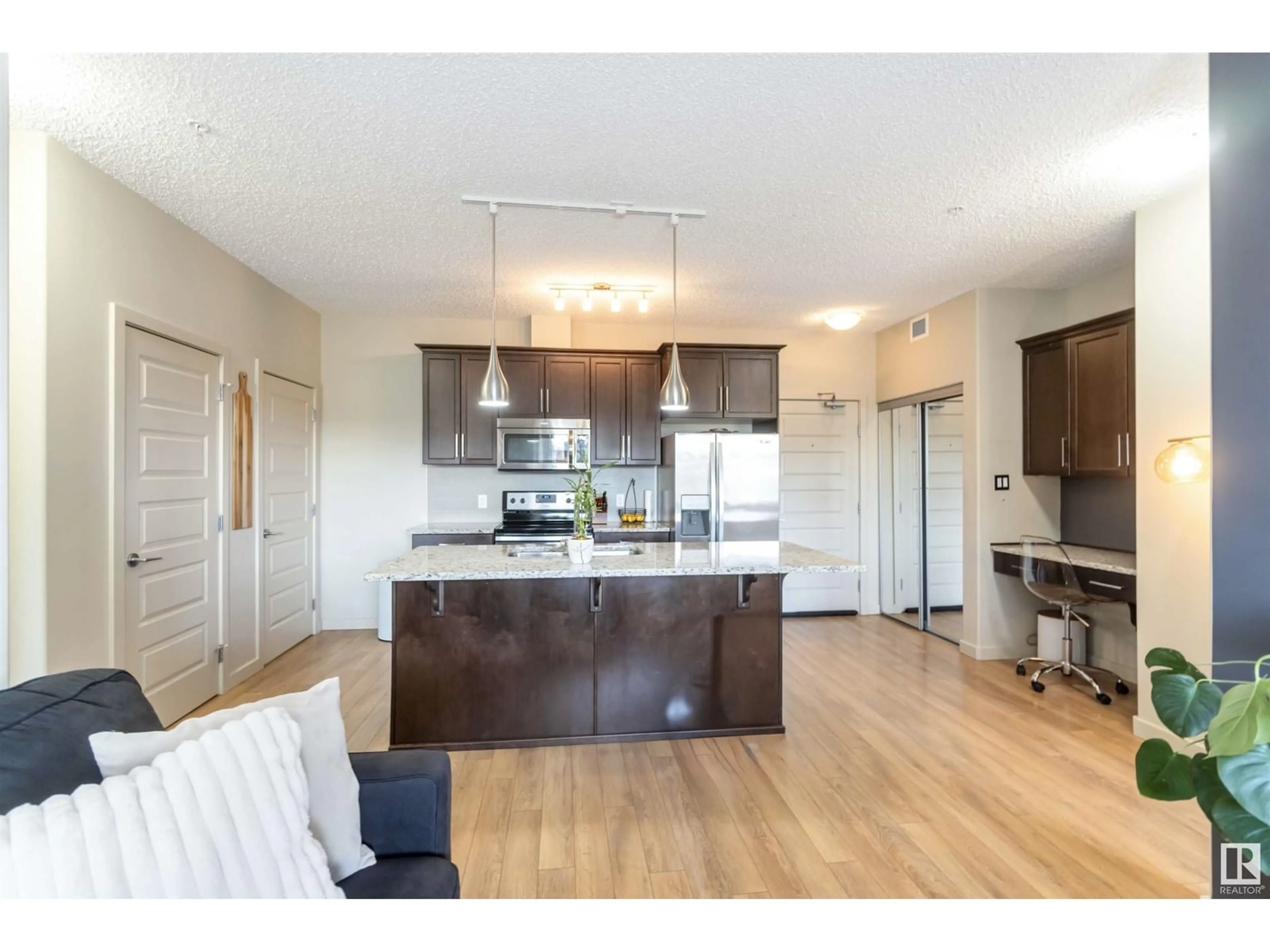 Open concept kitchen, wood/laminate floor for #133 - 503 ALBANY WY, Edmonton Alberta T6V0M5