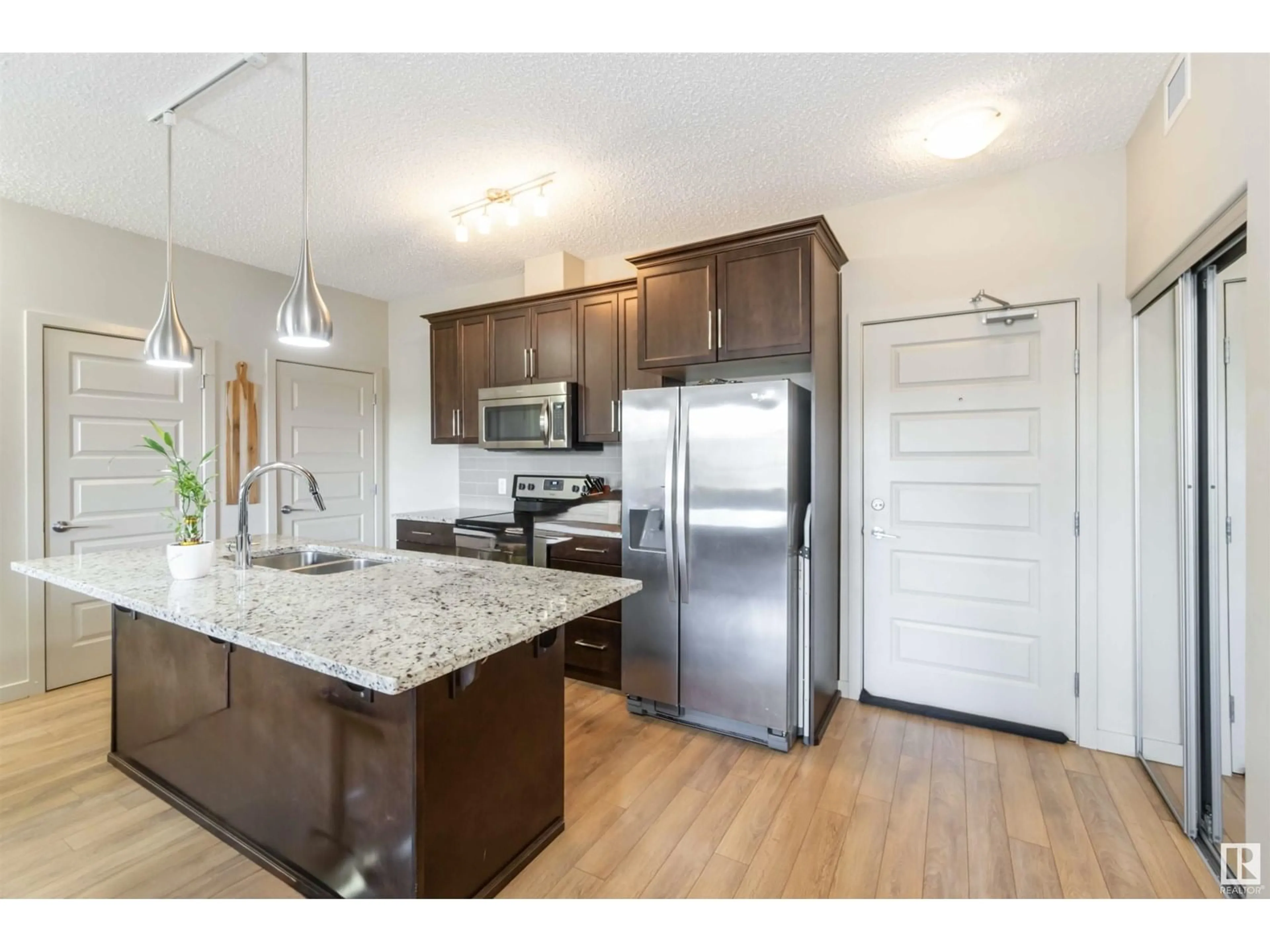 Open concept kitchen, wood/laminate floor for #133 - 503 ALBANY WY, Edmonton Alberta T6V0M5