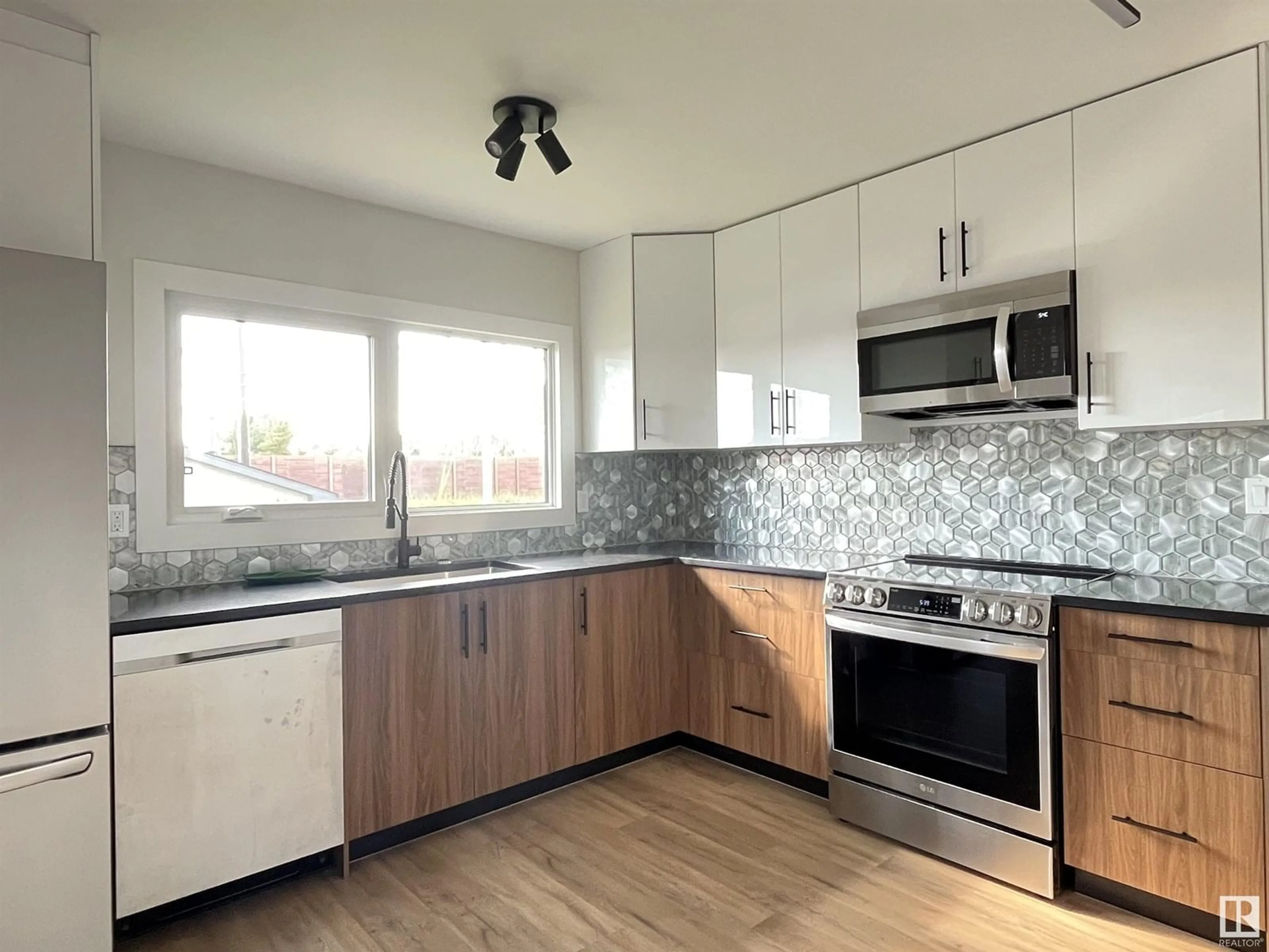 Open concept kitchen, wood/laminate floor for 9108 169 ST NW, Edmonton Alberta T5R2X1