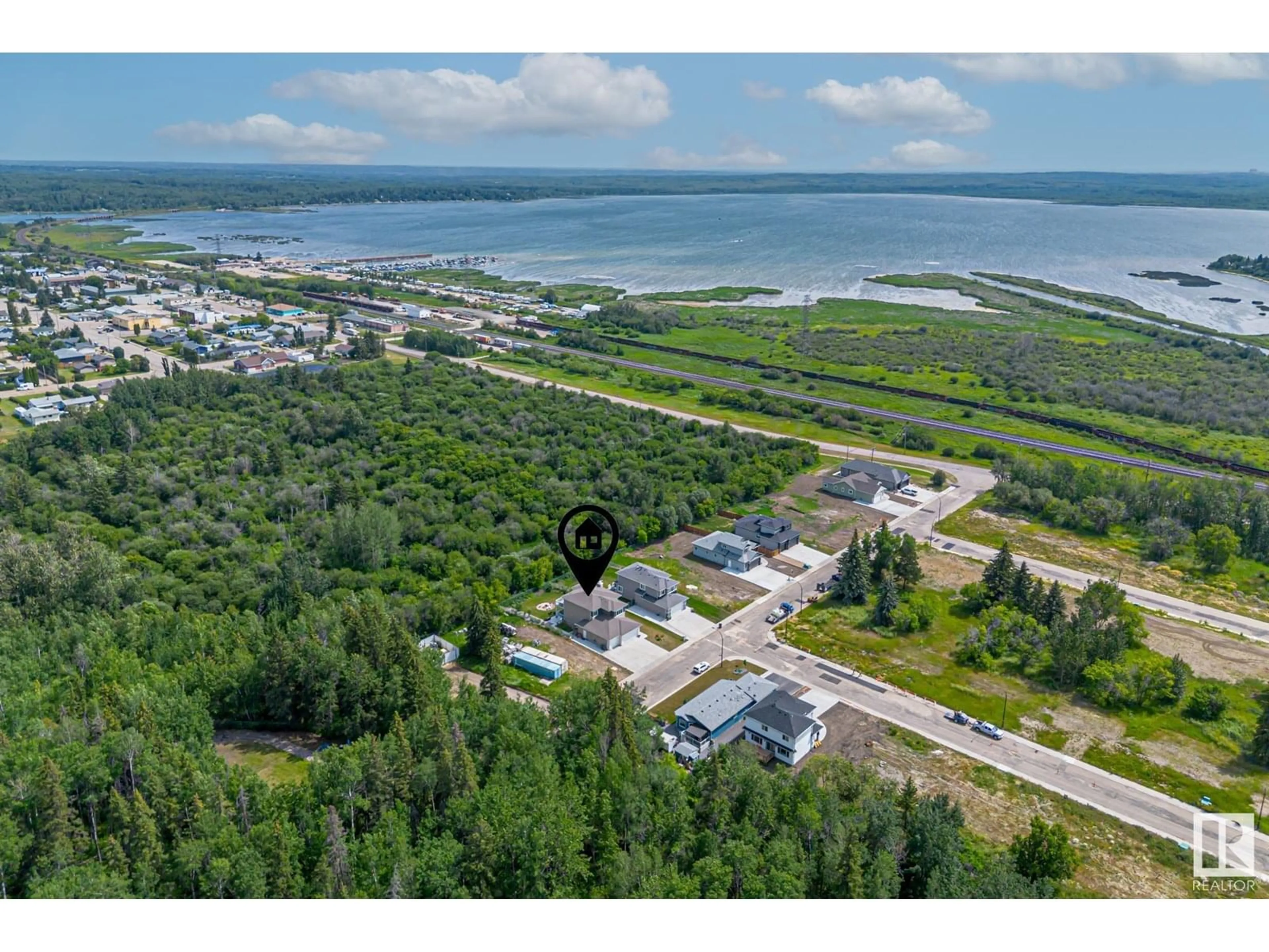 A pic from outside/outdoor area/front of a property/back of a property/a pic from drone, water/lake/river/ocean view for 55 - 5225 55 ST, Wabamun Alberta T0E2K0