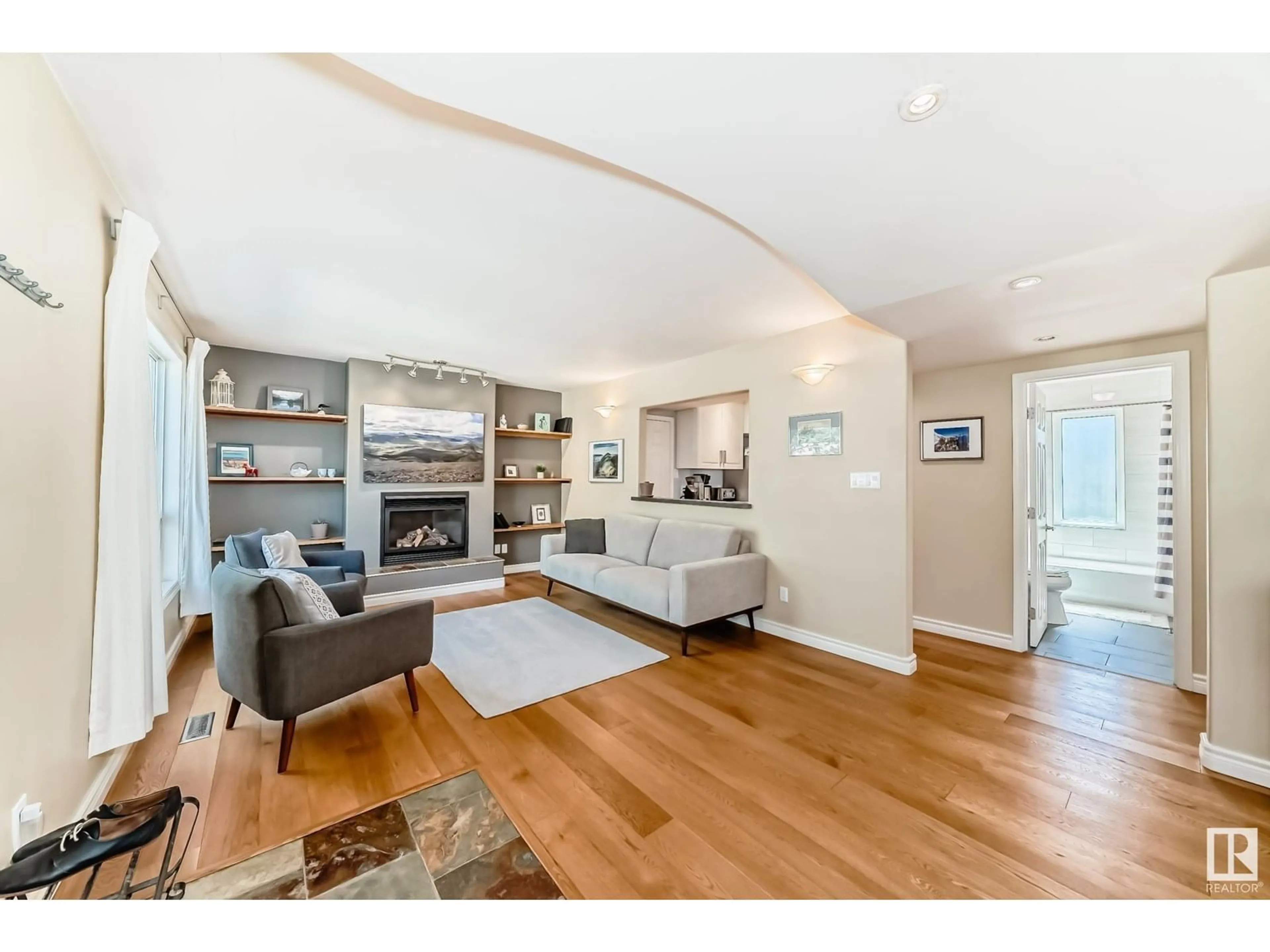 Living room with furniture, wood/laminate floor for 8347 81 AV, Edmonton Alberta T6C0W1