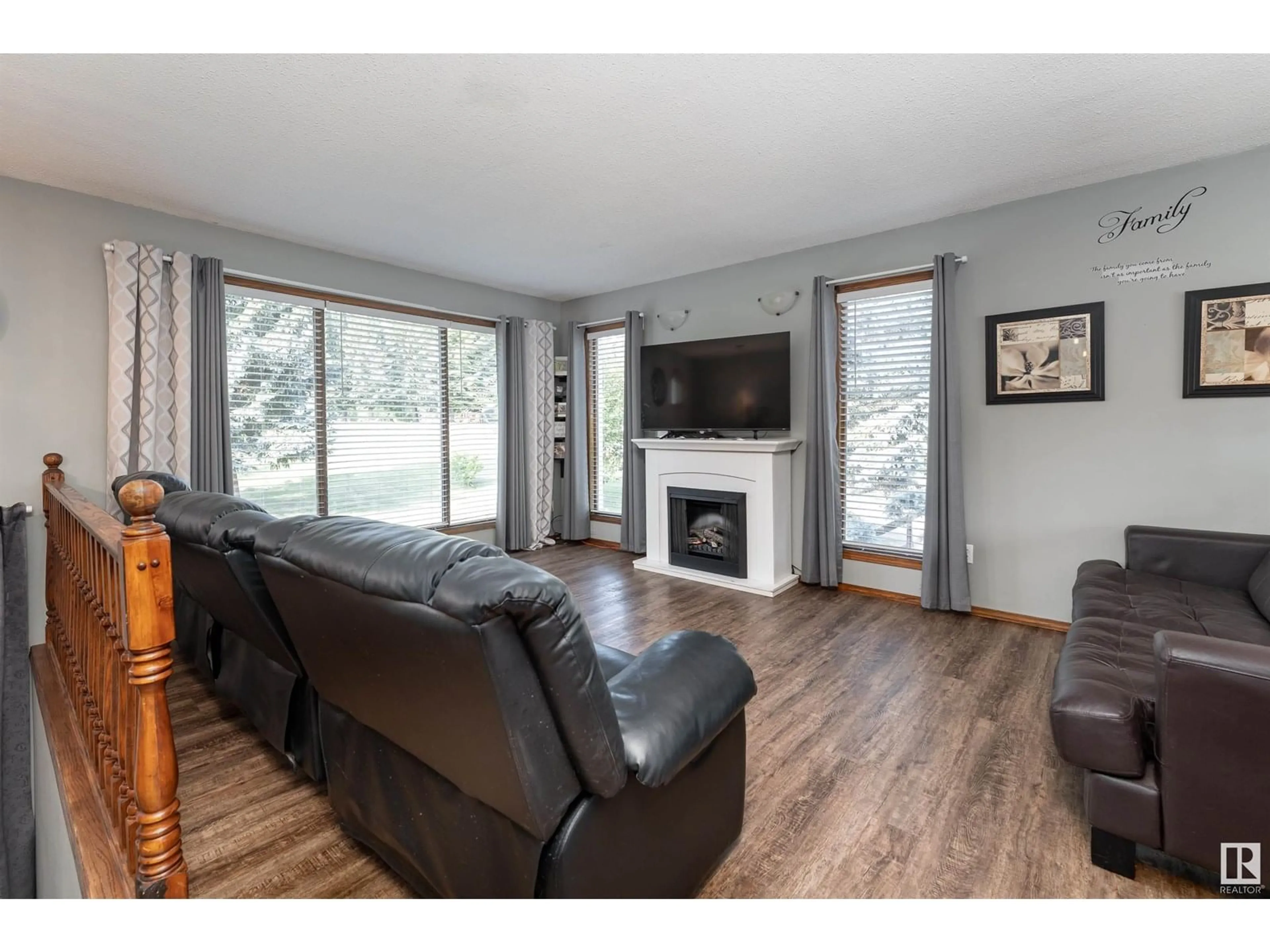 Living room with furniture, wood/laminate floor for #4 - 2228 PARKLAND DR, Rural Parkland County Alberta T7Y2L2