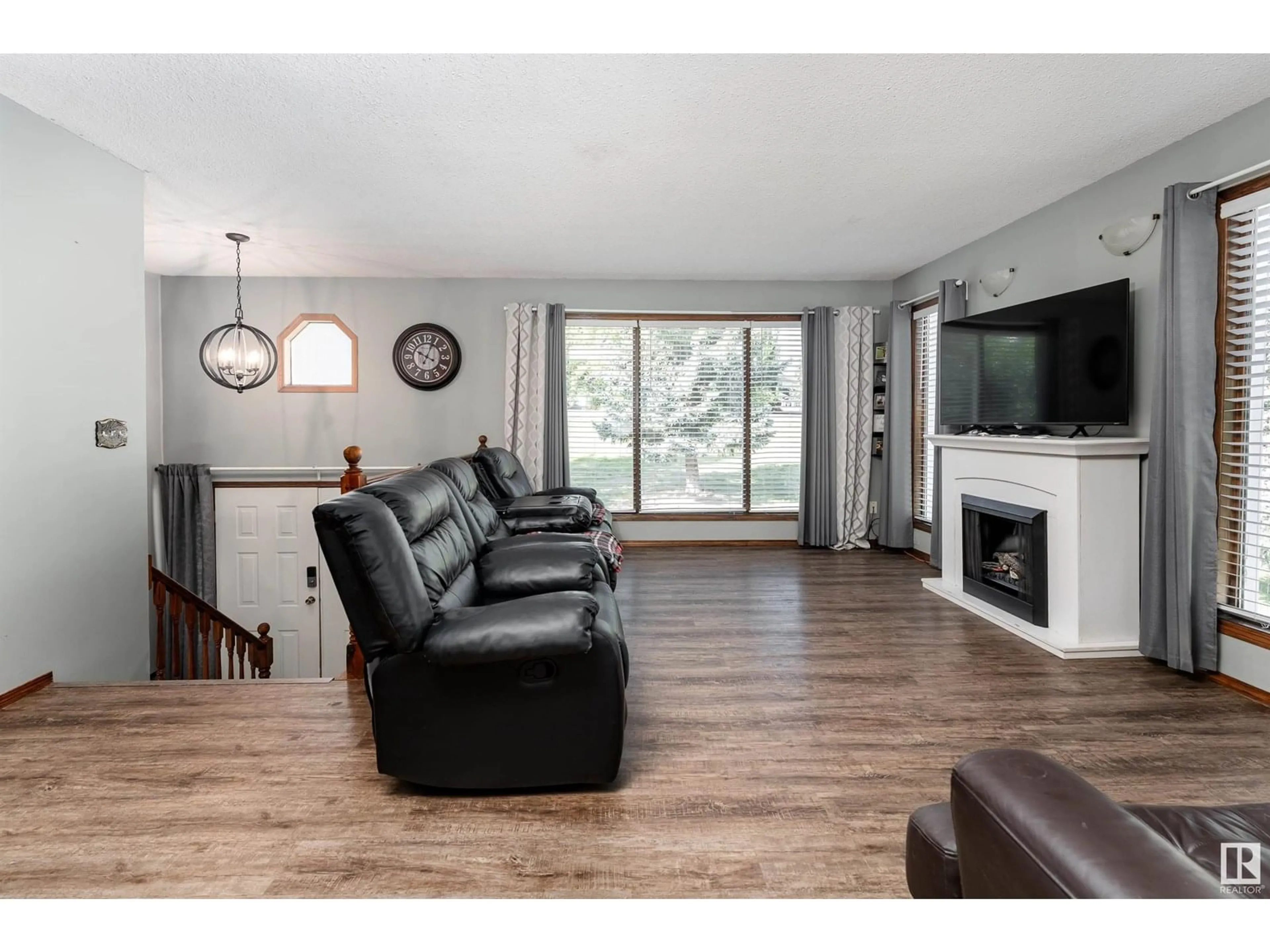 Living room with furniture, wood/laminate floor for #4 - 2228 PARKLAND DR, Rural Parkland County Alberta T7Y2L2