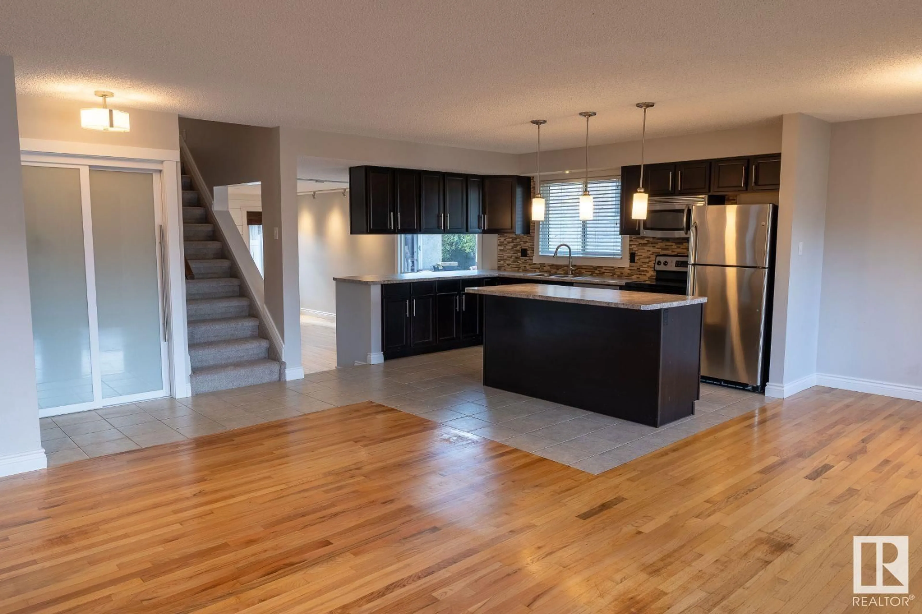 Open concept kitchen, wood/laminate floor for 9216 82 ST, Fort Saskatchewan Alberta T8L3P2