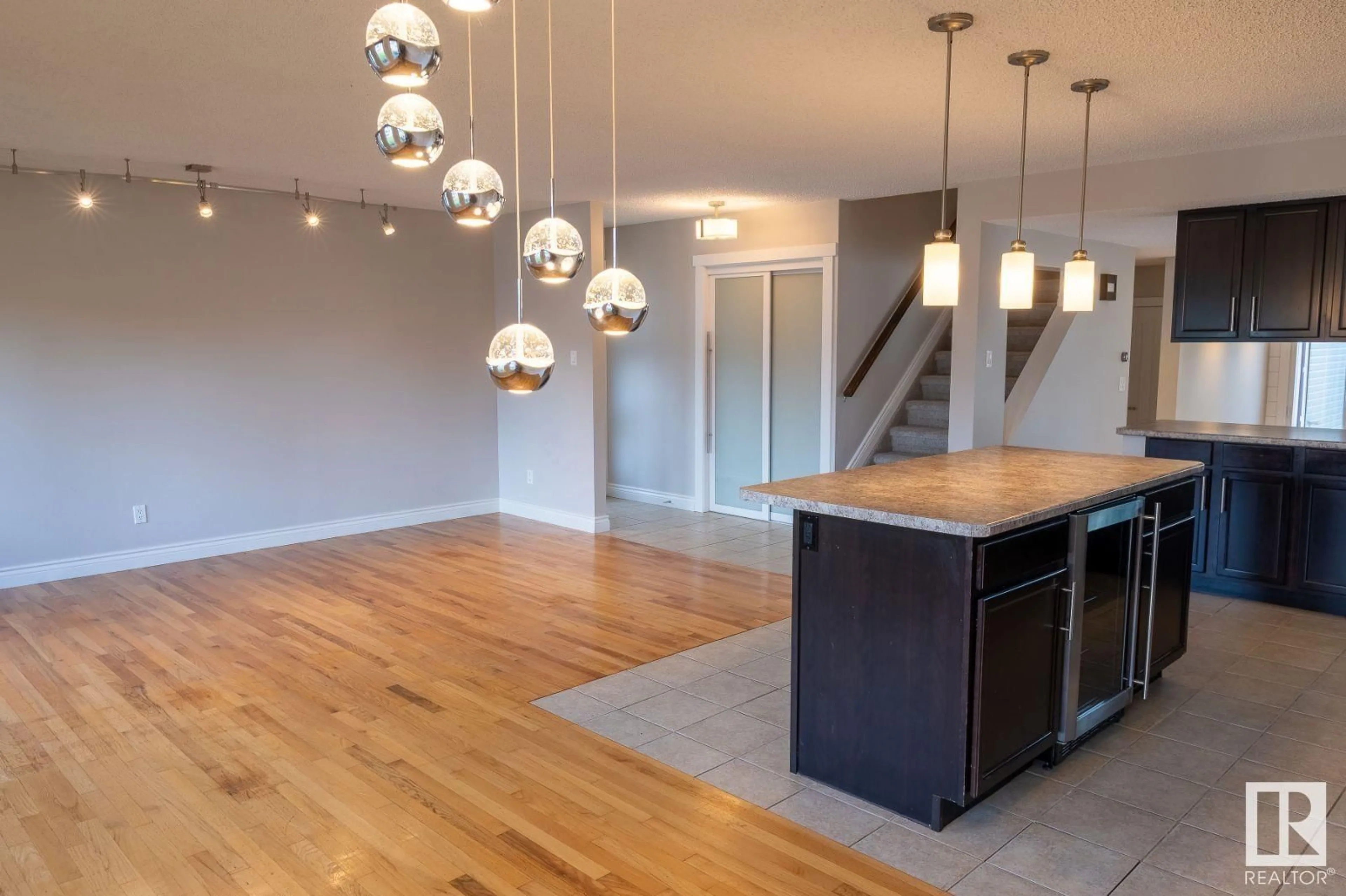 Open concept kitchen, wood/laminate floor for 9216 82 ST, Fort Saskatchewan Alberta T8L3P2