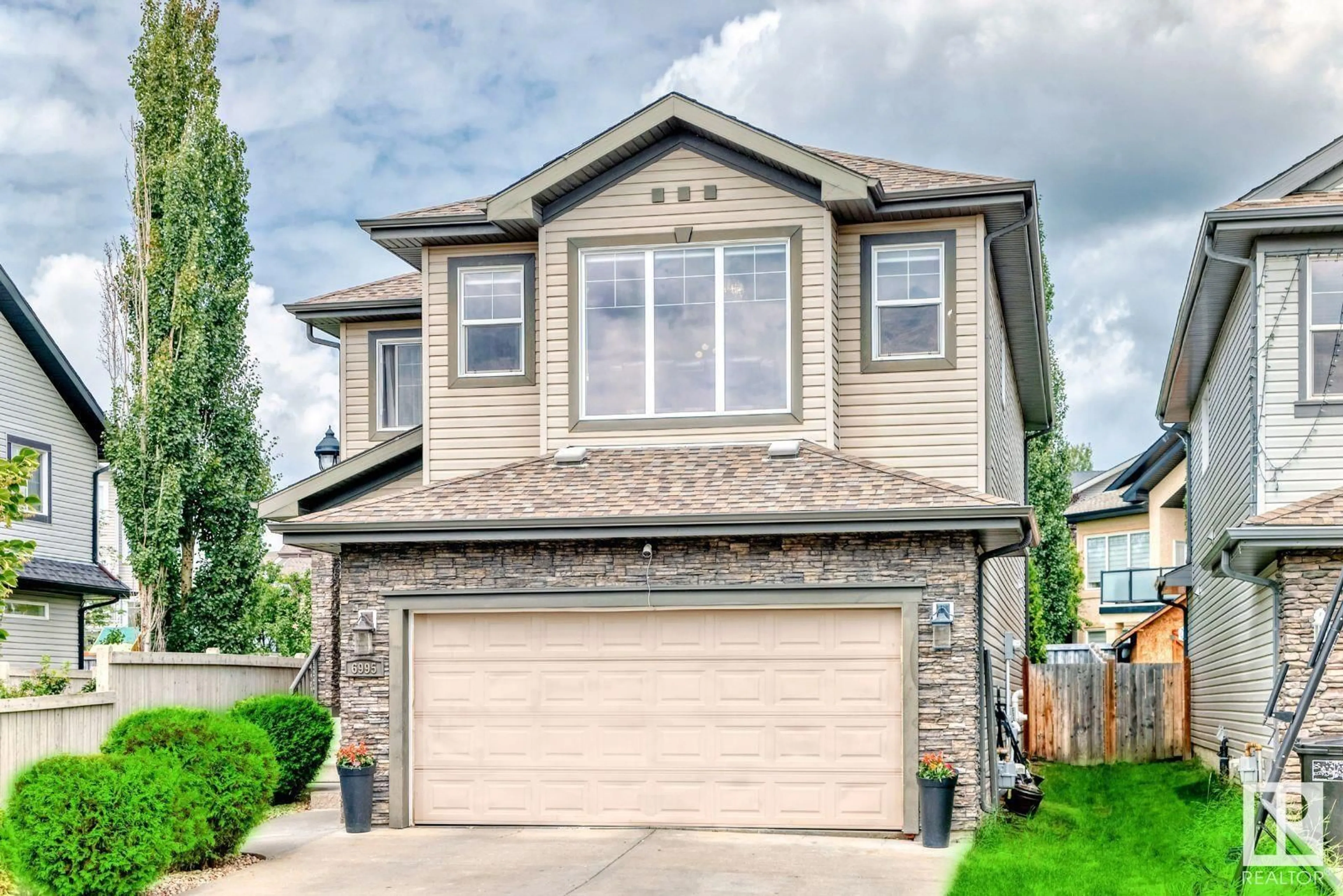 Home with vinyl exterior material, street for 6995 STROM LN, Edmonton Alberta T6R0P1