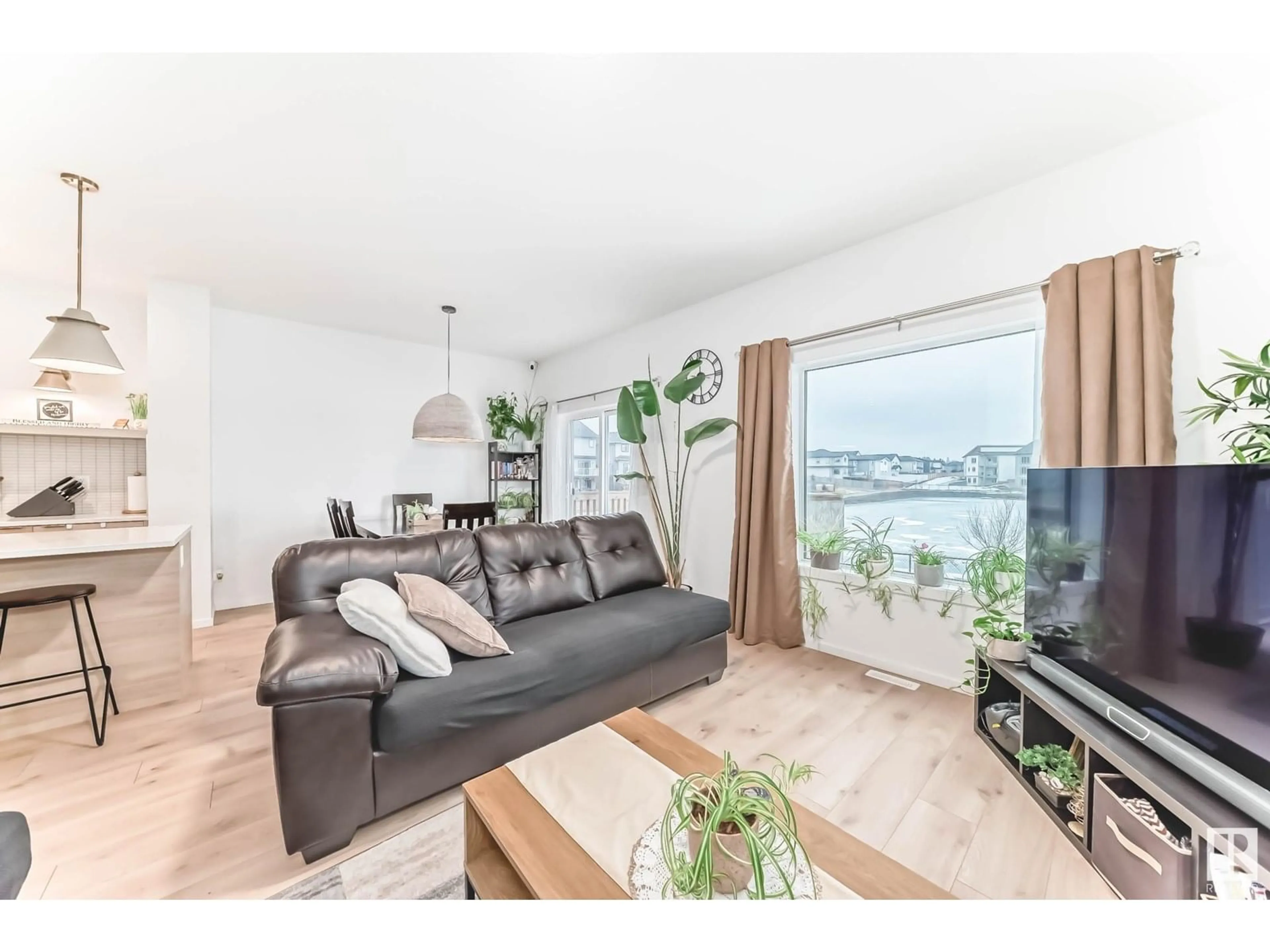 Living room with furniture, wood/laminate floor for 4595 66 ST, Beaumont Alberta T4X2Z4