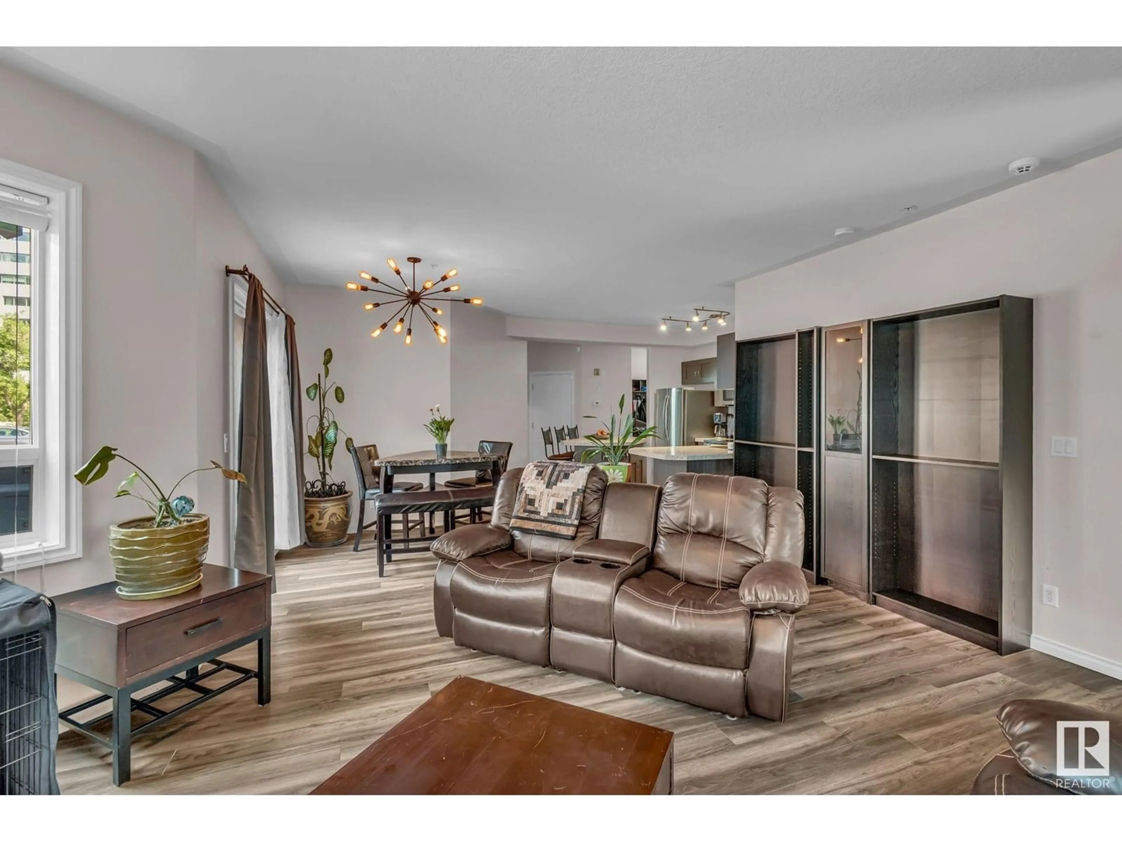 Living room with furniture, wood/laminate floor for #104 - 10046 110 ST NW, Edmonton Alberta T5K2Y2