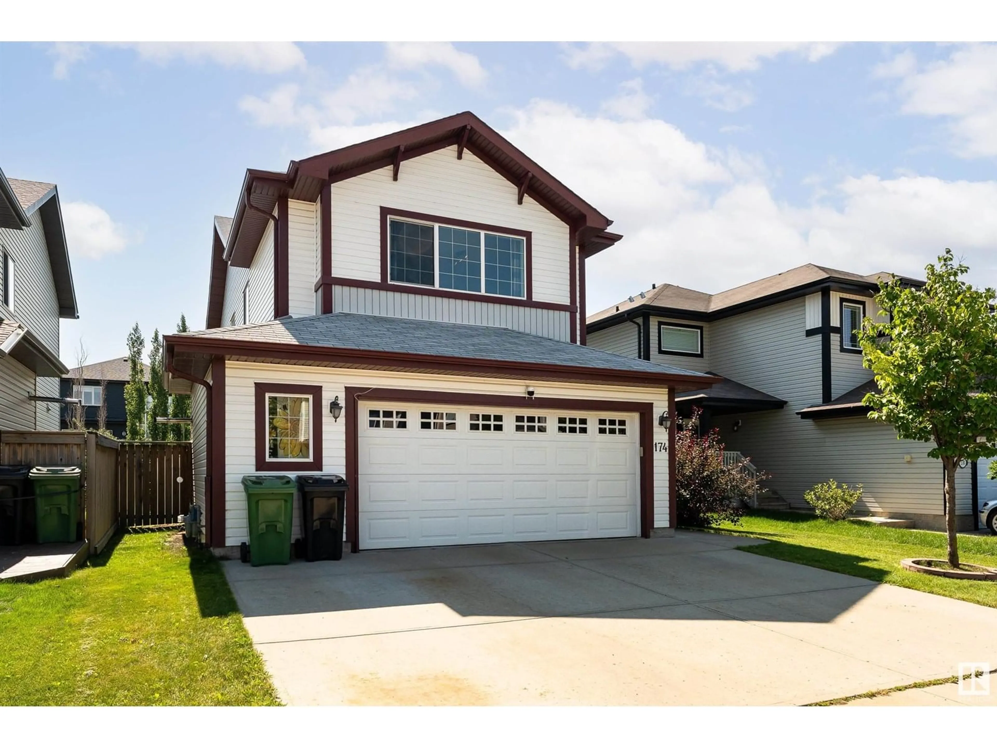 Home with vinyl exterior material, street for 174 WOODBEND WY, Fort Saskatchewan Alberta T8L4S4