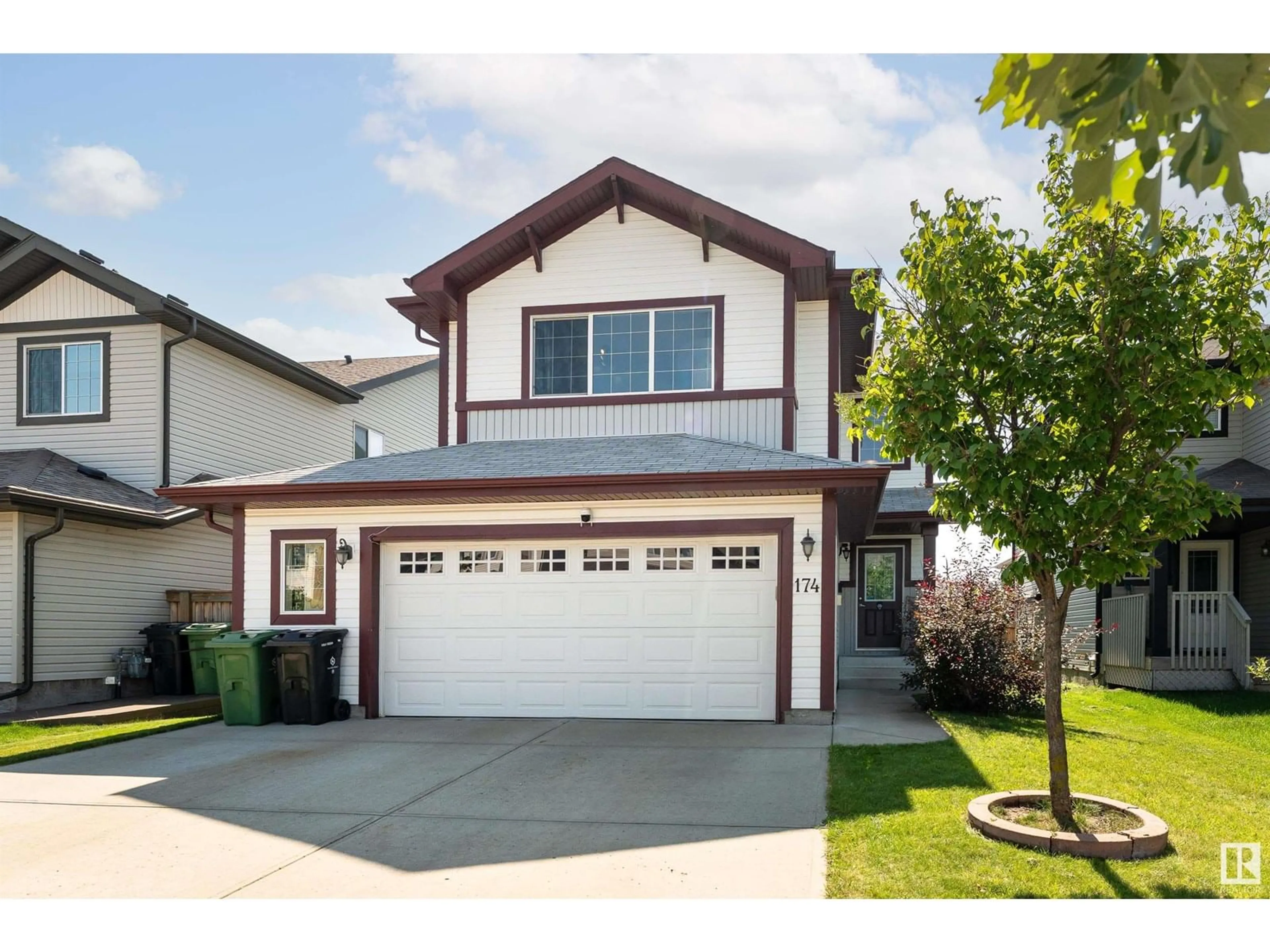 Home with vinyl exterior material, street for 174 WOODBEND WY, Fort Saskatchewan Alberta T8L4S4