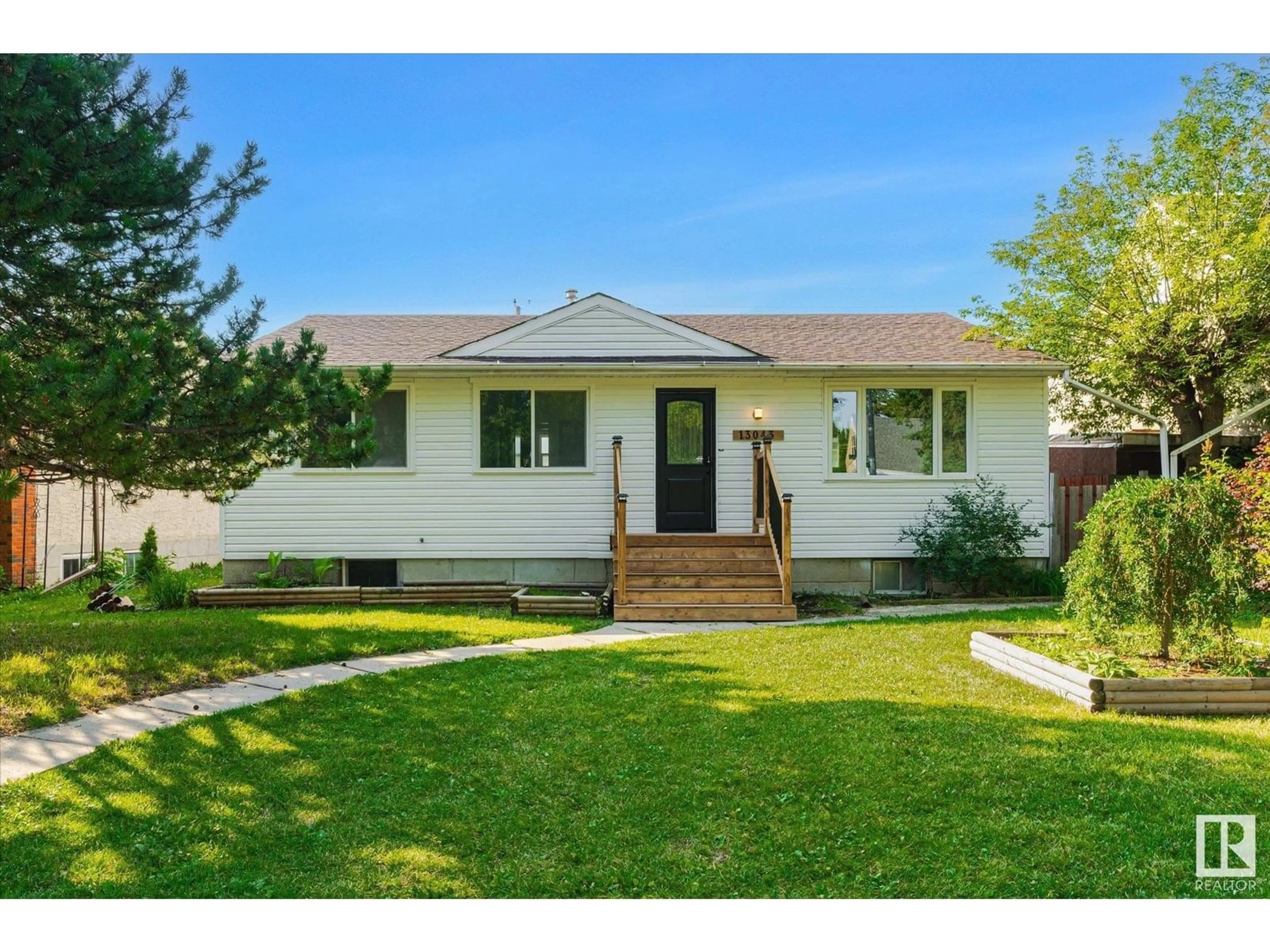 Home with vinyl exterior material, street for 13043 SHERBROOKE AV, Edmonton Alberta T5L4E6