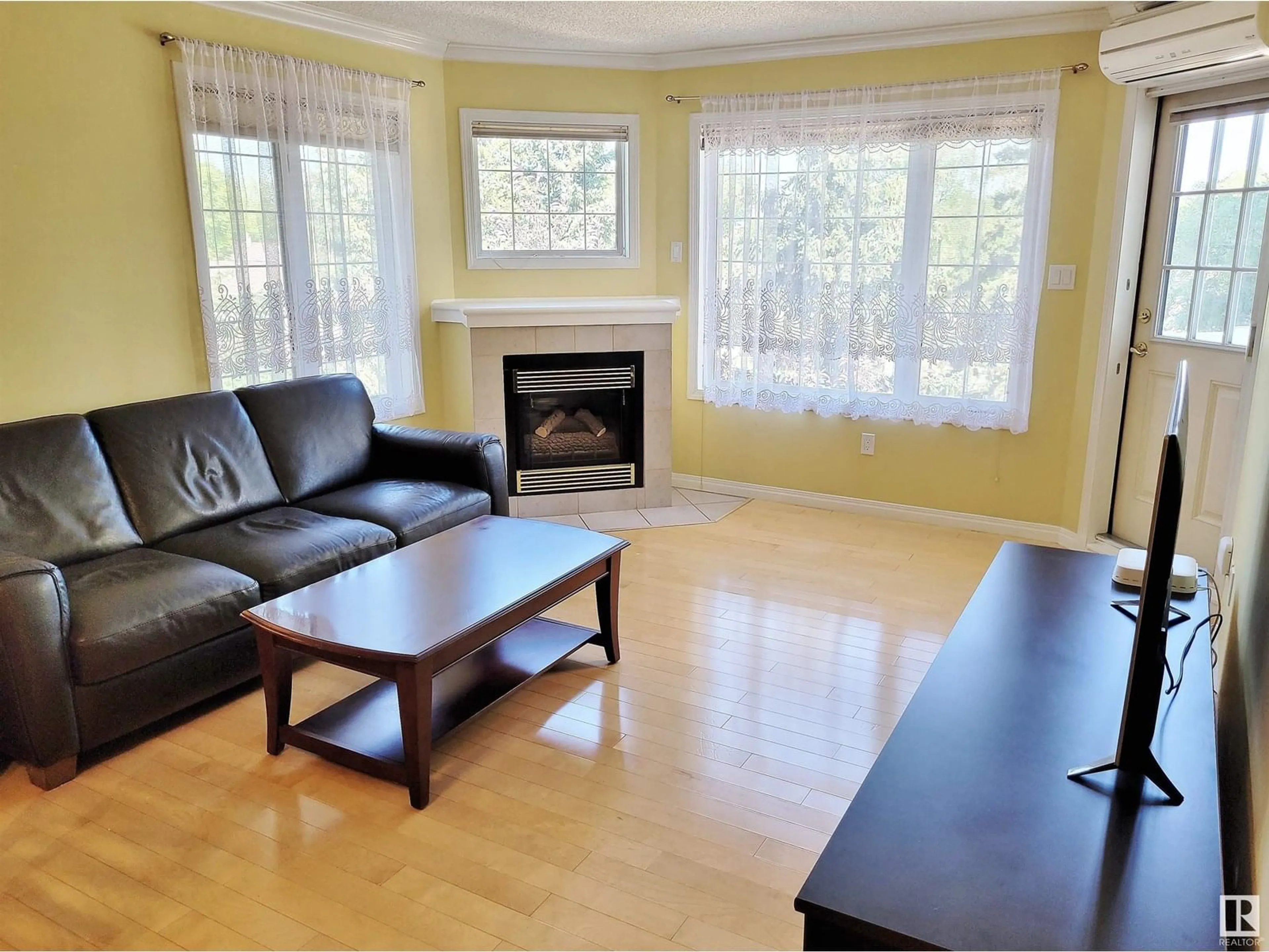 Living room with furniture, wood/laminate floor for 404 - 13450 114 AV, Edmonton Alberta T5M4C4
