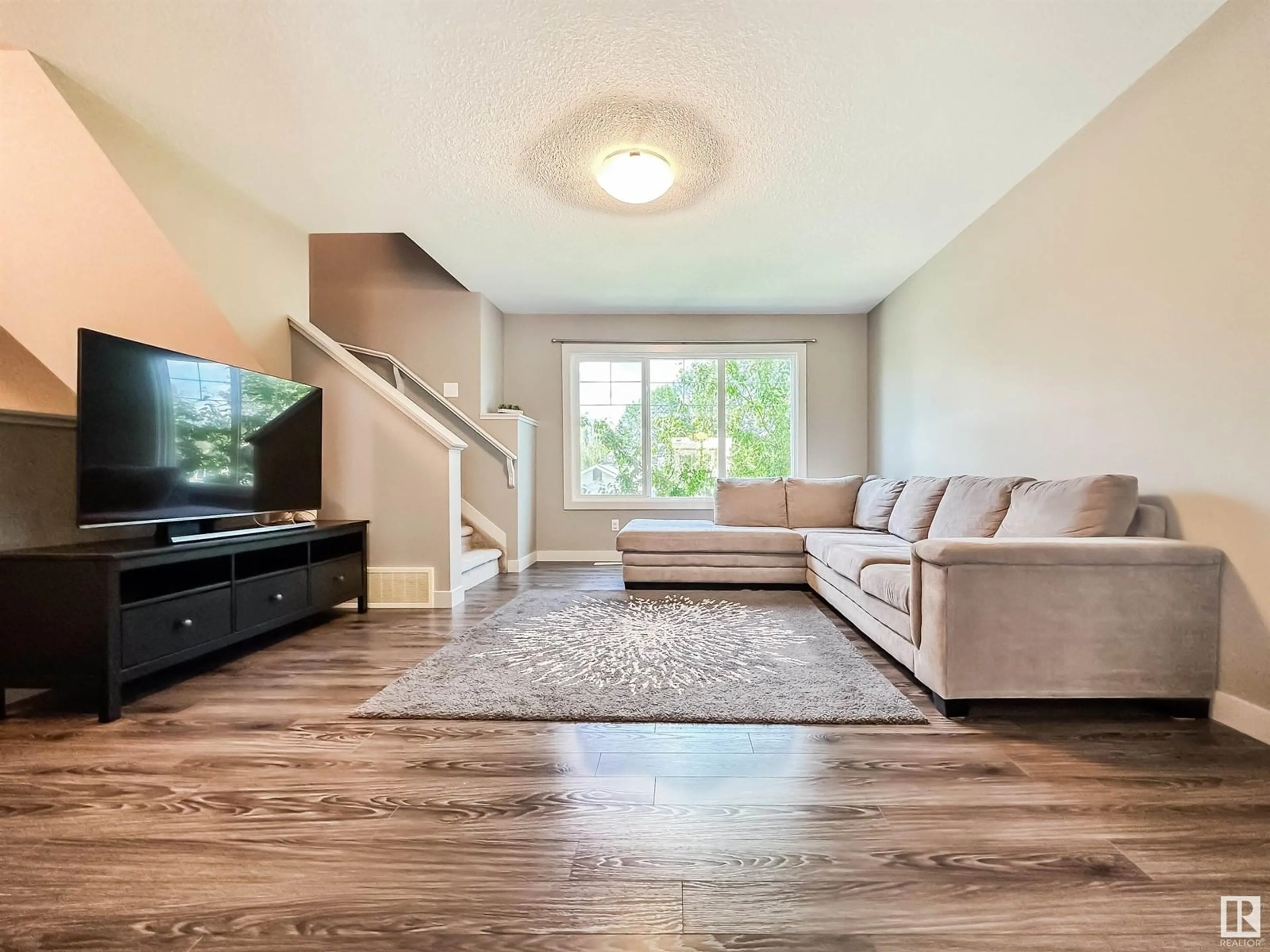 Living room with furniture, wood/laminate floor for 4217 30 ST, Edmonton Alberta T6T2G9