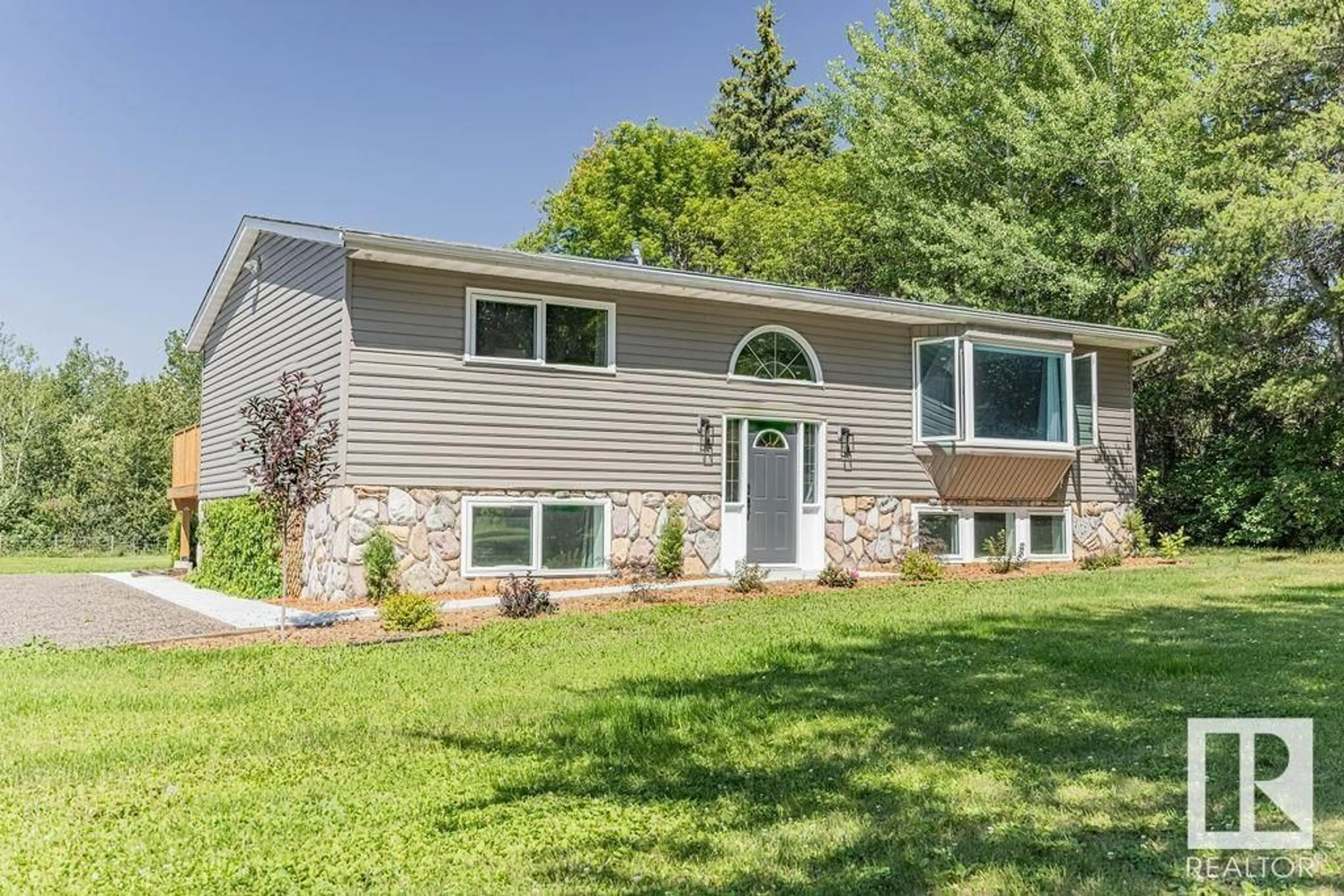 Home with vinyl exterior material, street for 51526 - 12 RGE ROAD 273, Rural Parkland County Alberta T7Y1H7
