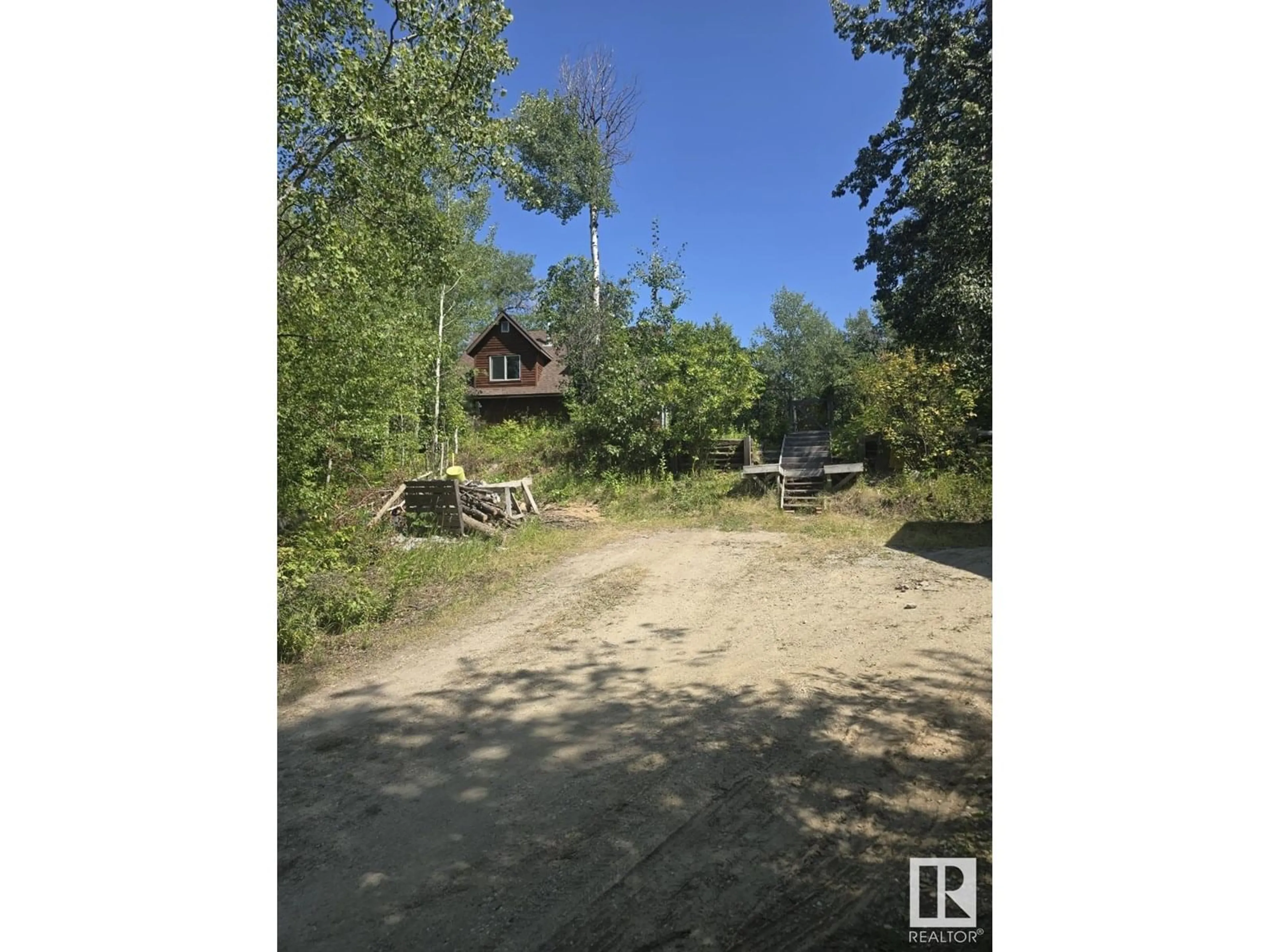 A pic from outside/outdoor area/front of a property/back of a property/a pic from drone, forest/trees view for 54425 - 205 STE. ANNE TR, Rural Lac Ste. Anne County Alberta T0E0B0