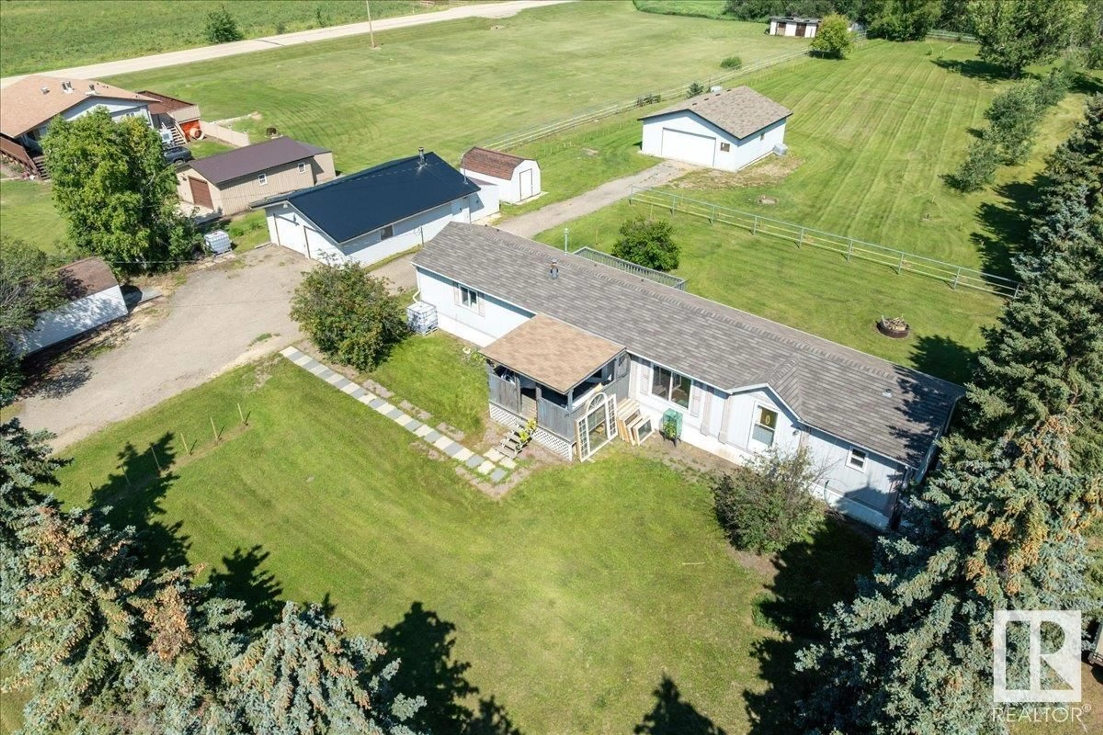 A pic from outside/outdoor area/front of a property/back of a property/a pic from drone, unknown for #106 - 49427 RANGE ROAD 211 A, Rural Camrose County Alberta T4V1N1
