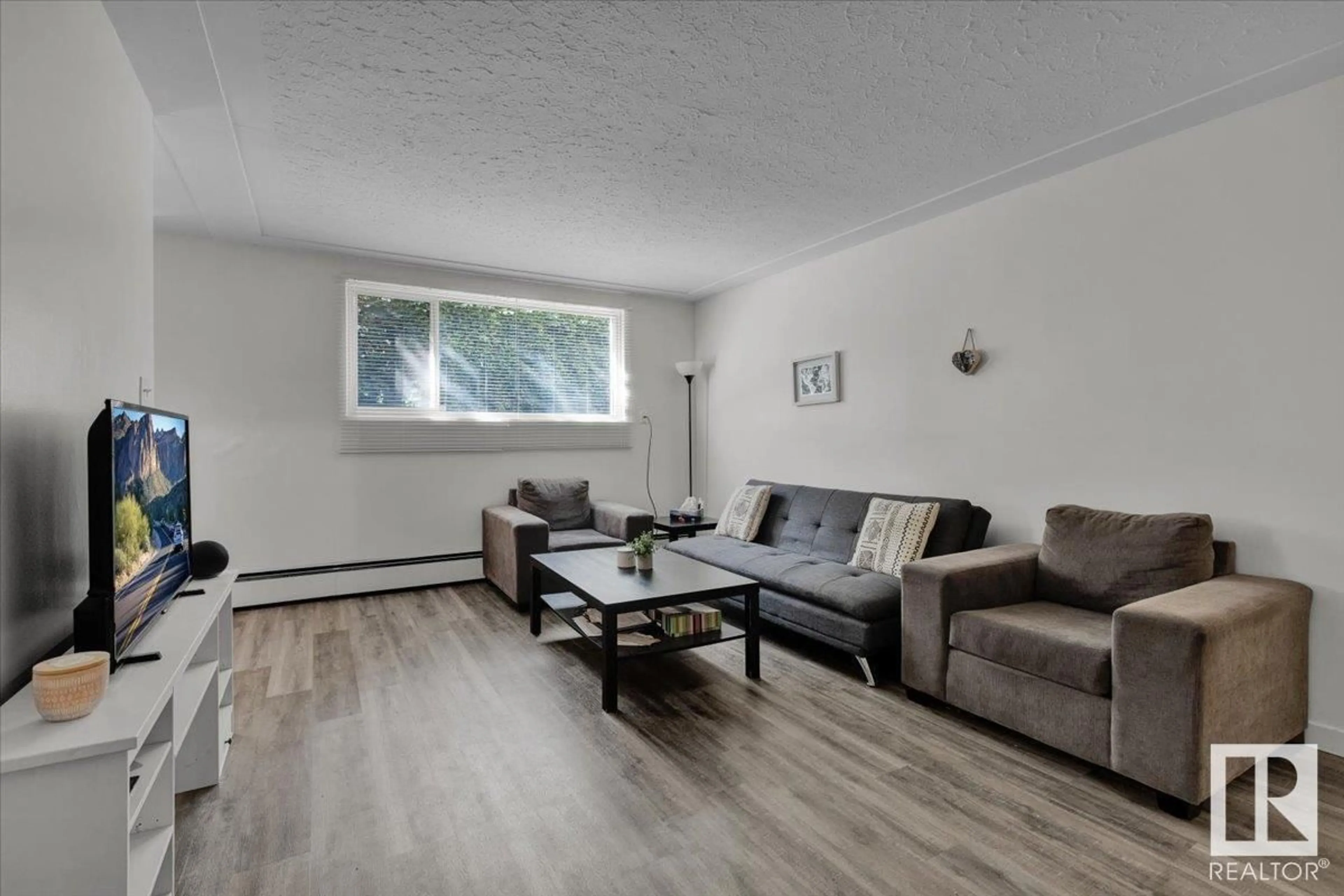 Living room with furniture, wood/laminate floor for #3 - 10625 107 AV, Edmonton Alberta T5H0W5