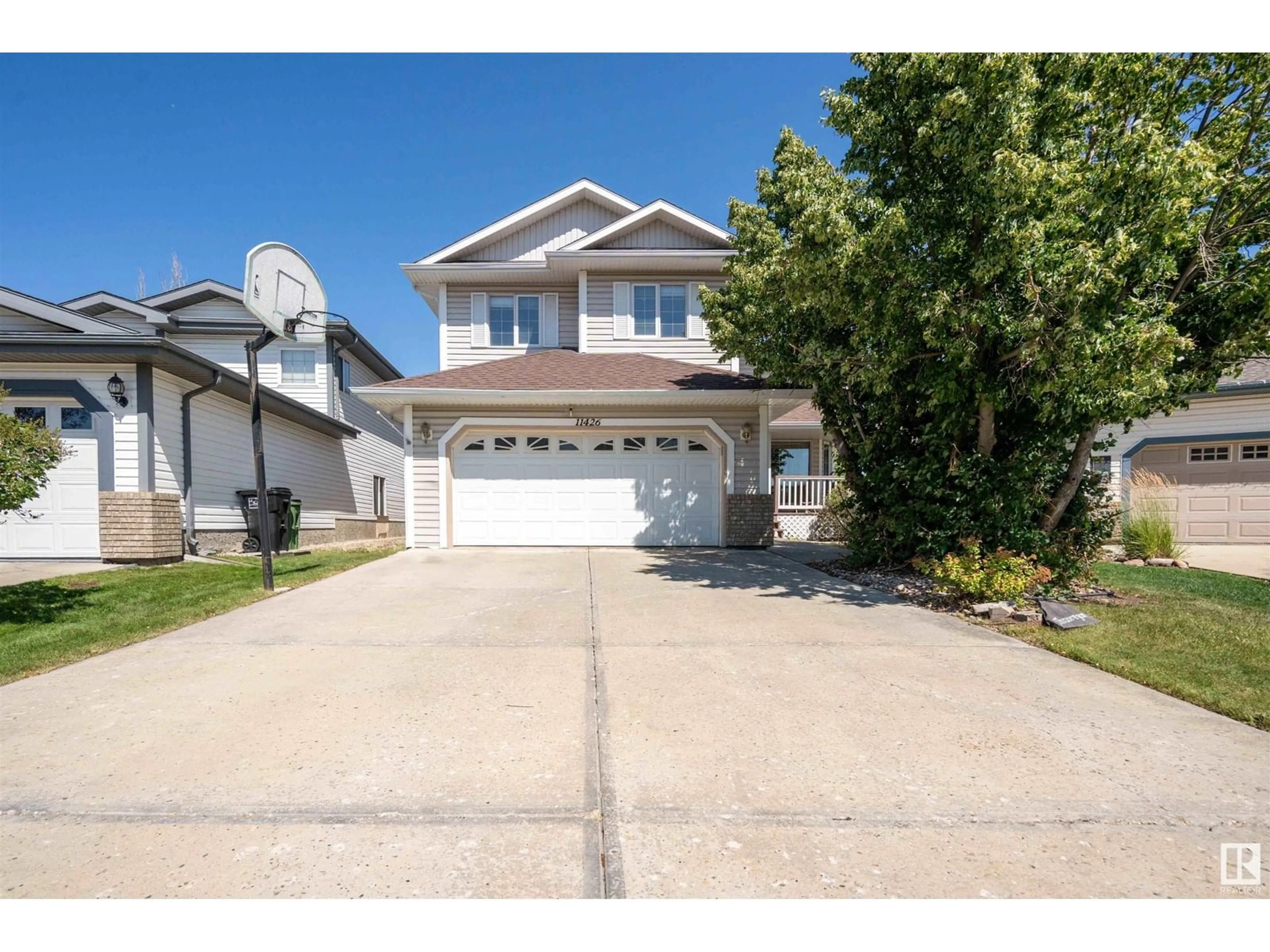 Home with vinyl exterior material, street for 11426 9A AVE AVE, Edmonton Alberta T6J7B2