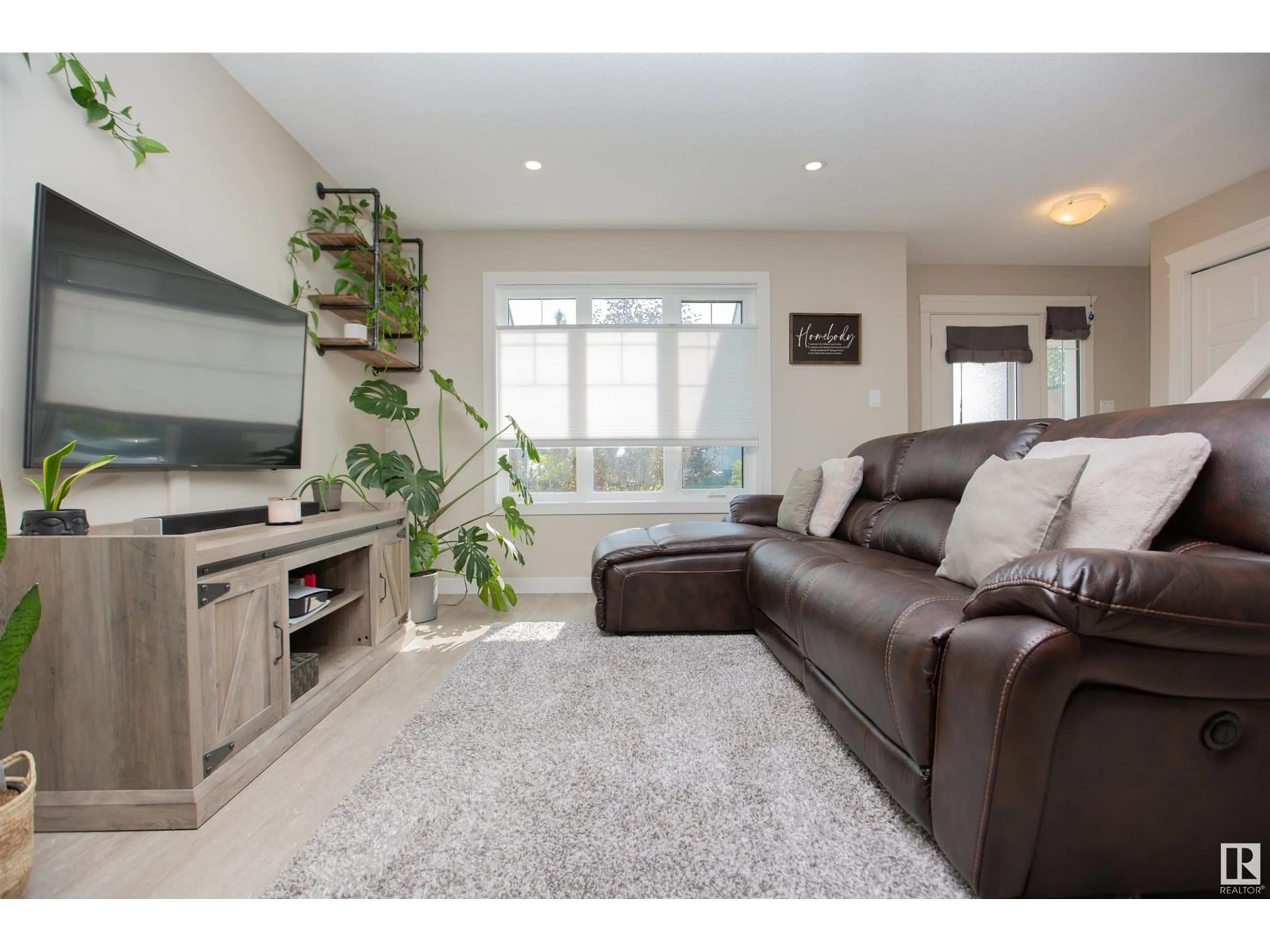 Living room with furniture, wood/laminate floor for 5710 65 ST, Beaumont Alberta T4X2A4
