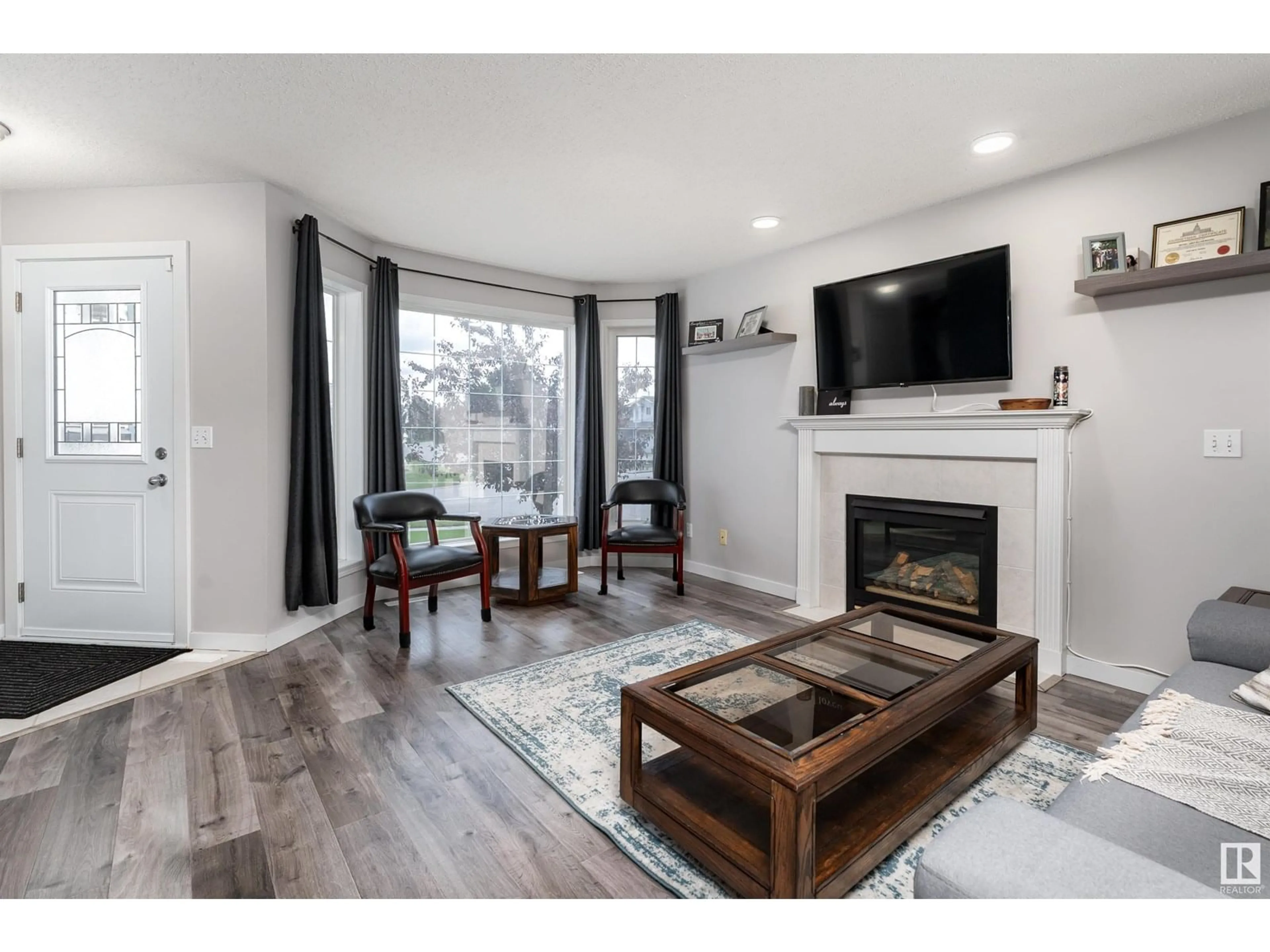 Living room with furniture, wood/laminate floor for 9917 94 ST, Fort Saskatchewan Alberta T8L4J5