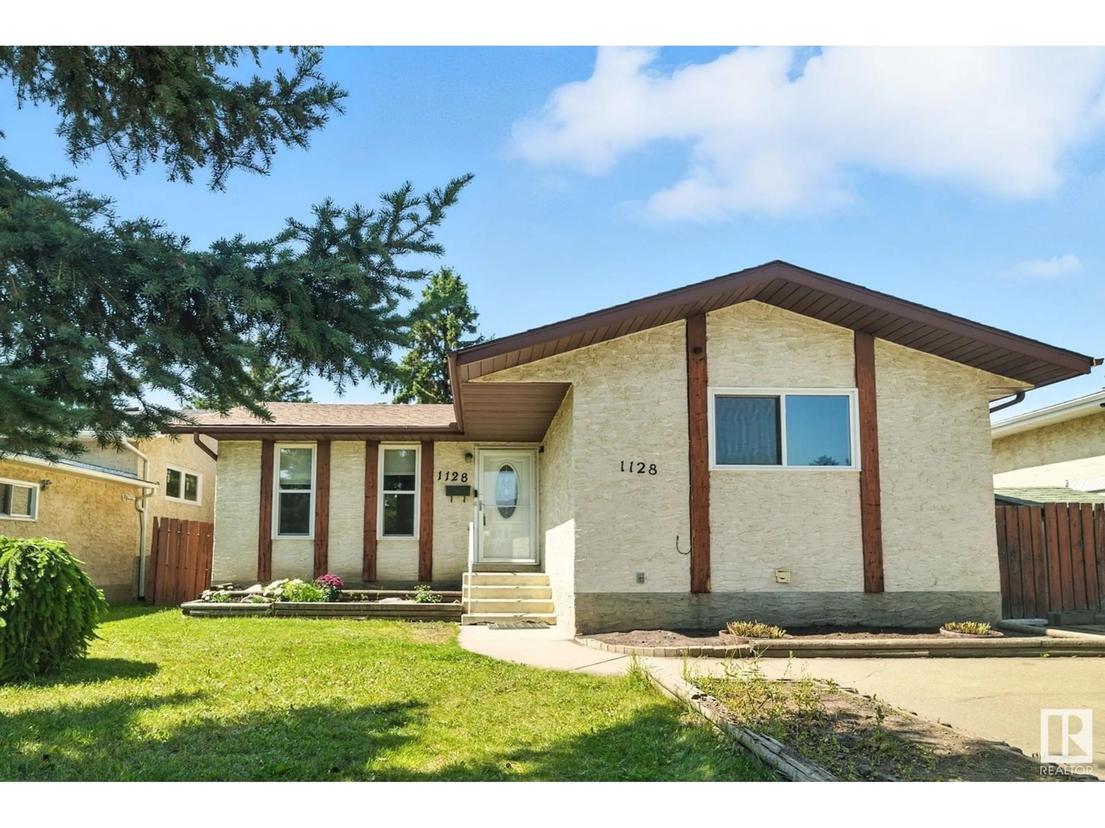 Home with vinyl exterior material, street for 1128 61 ST, Edmonton Alberta T6L3Z9