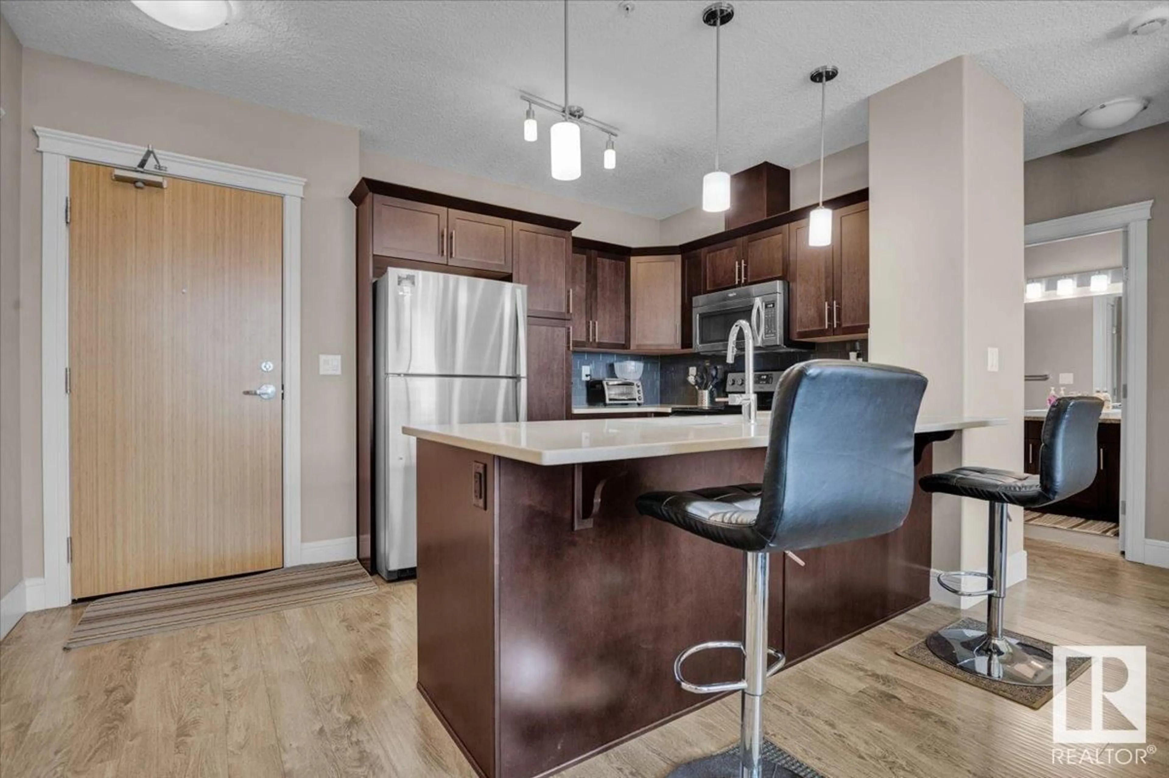 Open concept kitchen, wood/laminate floor for #419 - 7508 GETTY GATE, Edmonton Alberta T5T7E6
