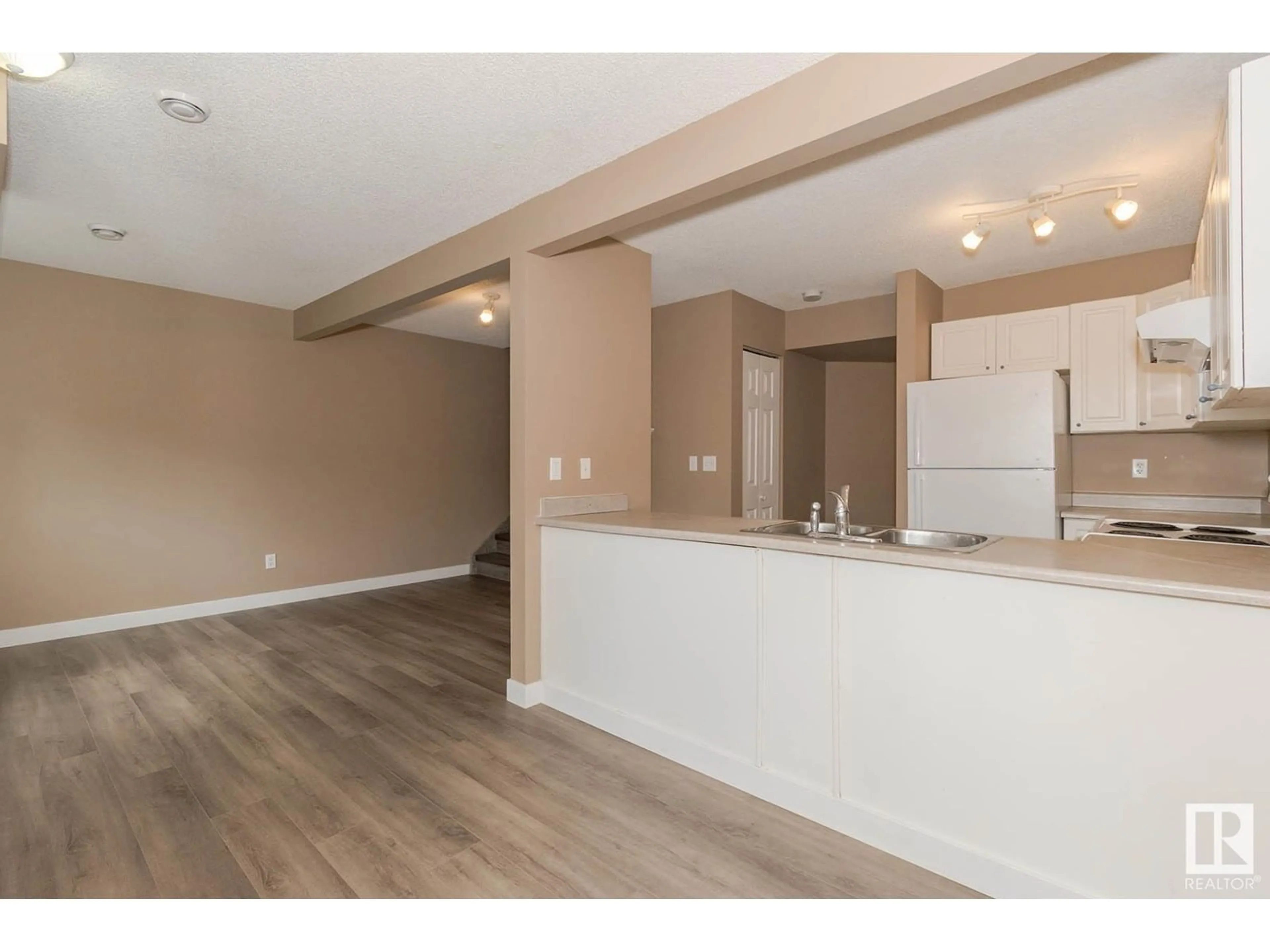 Open concept kitchen, wood/laminate floor for 140 166 BRIDGEPORT BV, Leduc Alberta T9E0J8