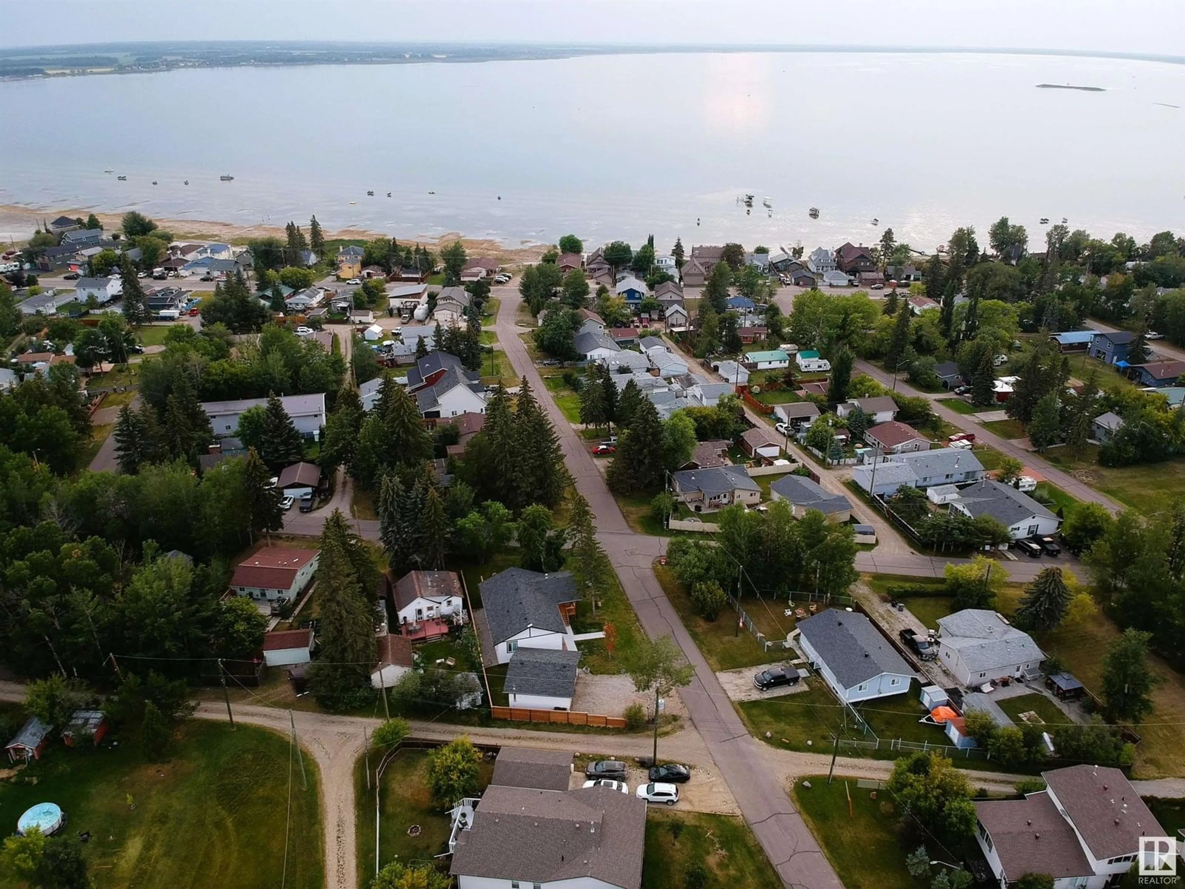 A pic from outside/outdoor area/front of a property/back of a property/a pic from drone, water/lake/river/ocean view for 4407 47 AV, Rural Lac Ste. Anne County Alberta T0E0A0