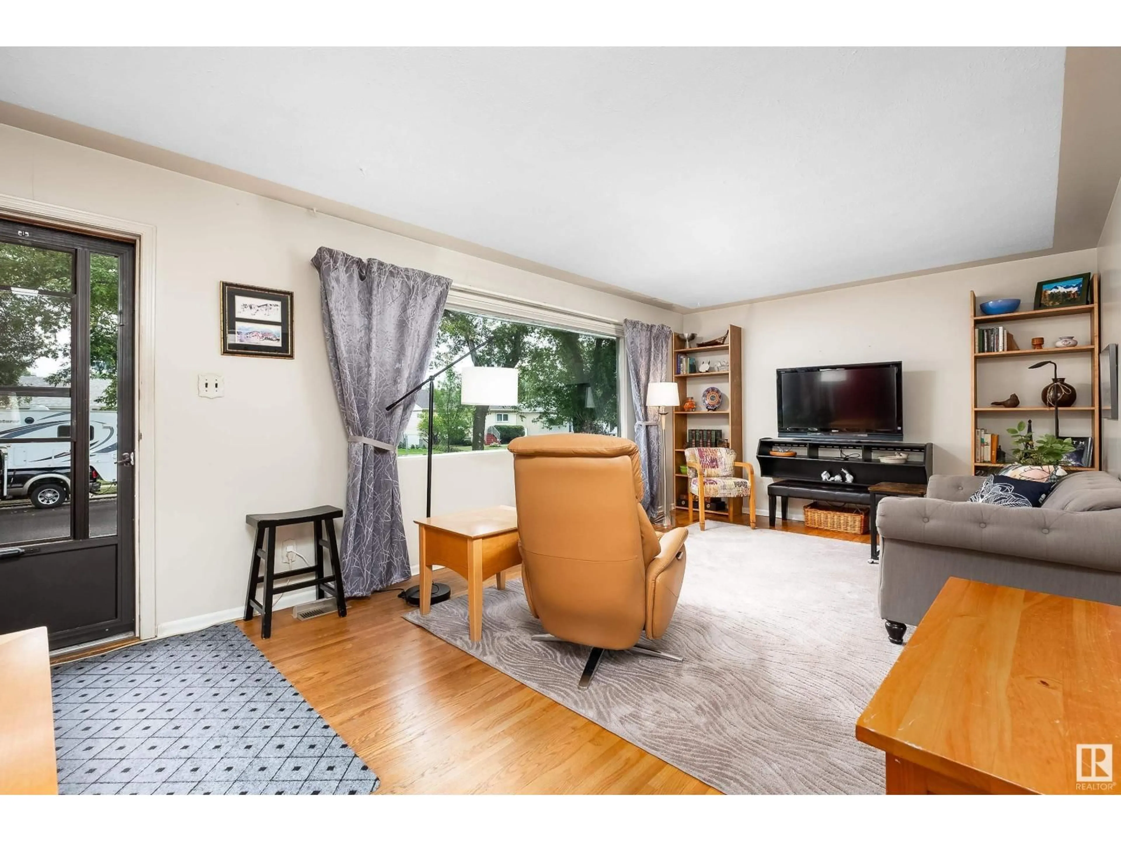 Living room with furniture, wood/laminate floor for NW - 13120 63 ST, Edmonton Alberta T5A0W8