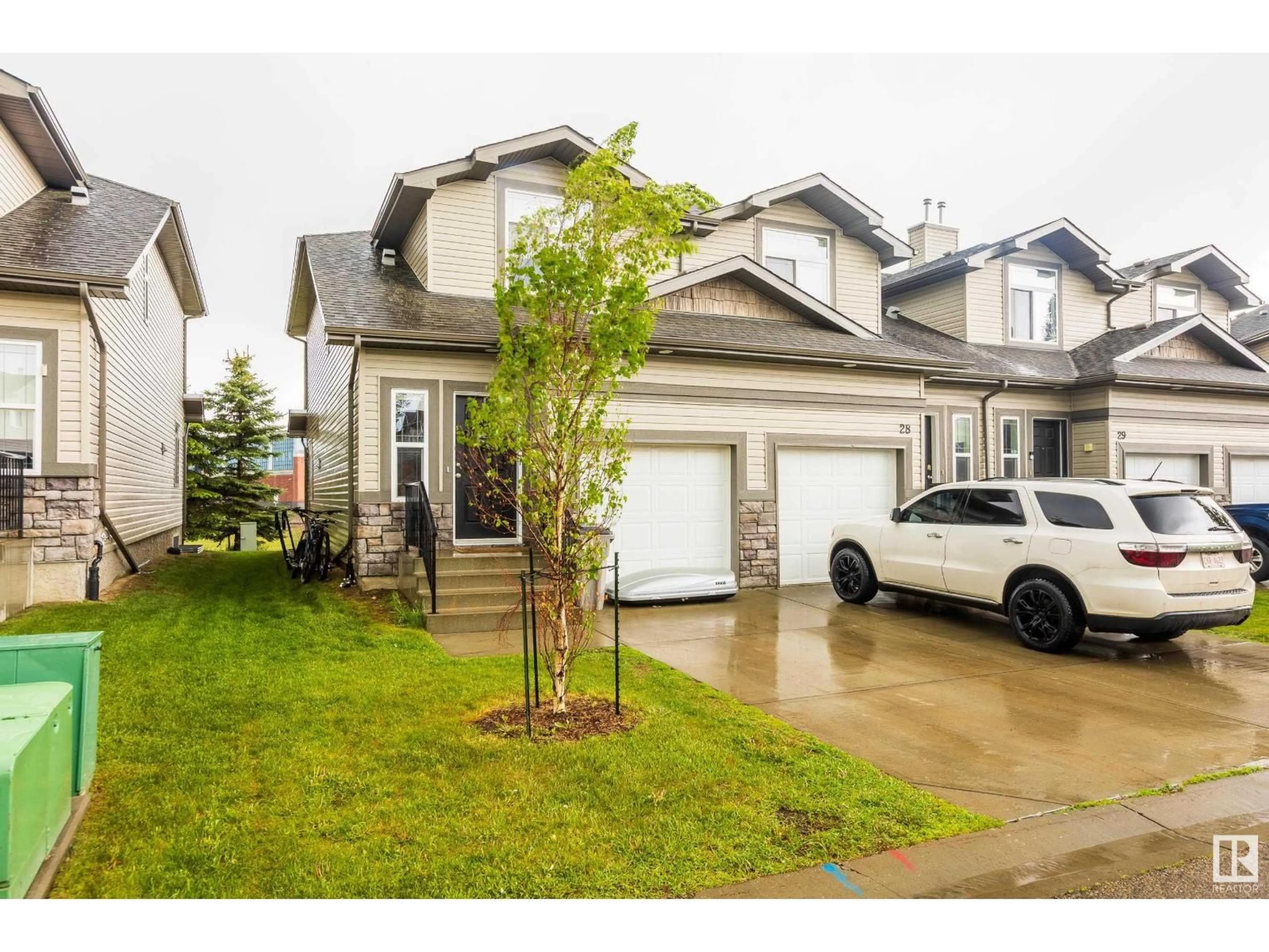 Home with vinyl exterior material, street for 27 9511 102 AV, Morinville Alberta T8R0C6