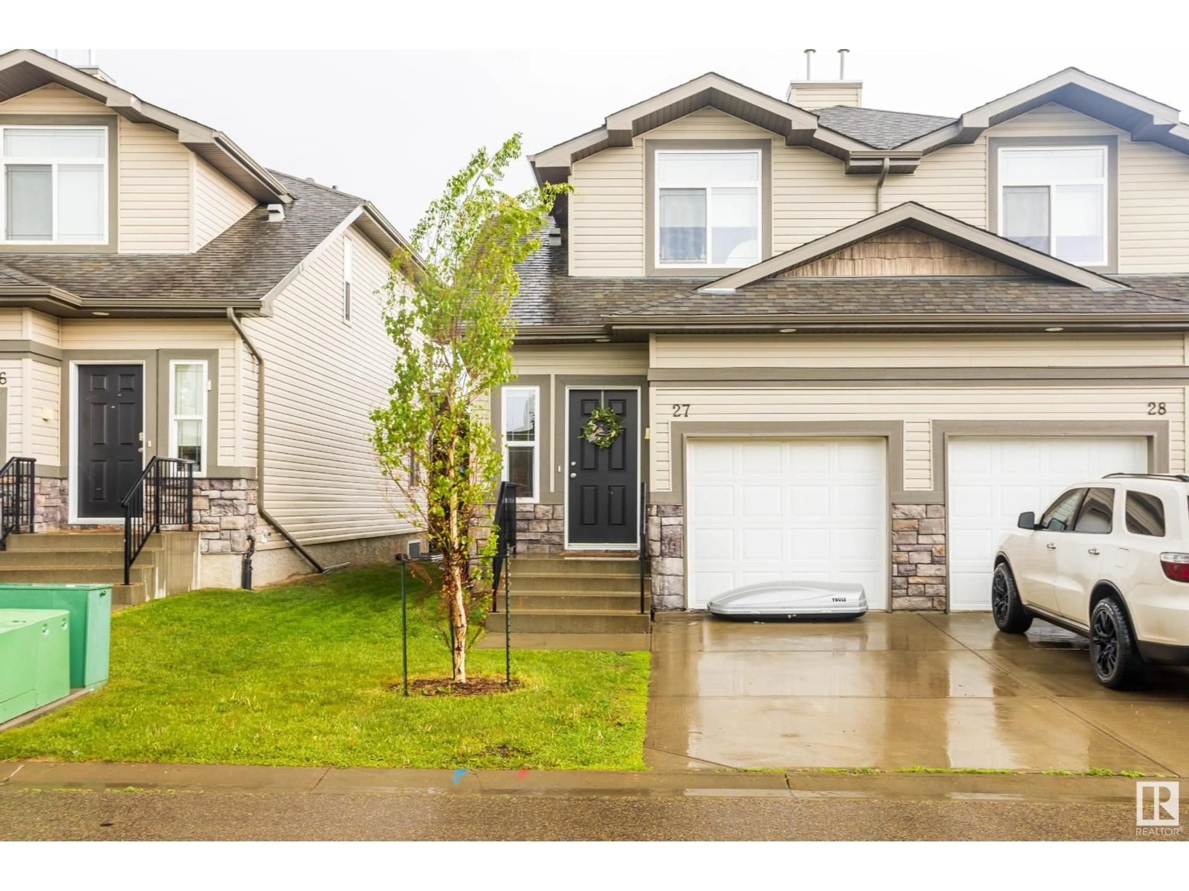 Home with vinyl exterior material, street for 27 9511 102 AV, Morinville Alberta T8R0C6