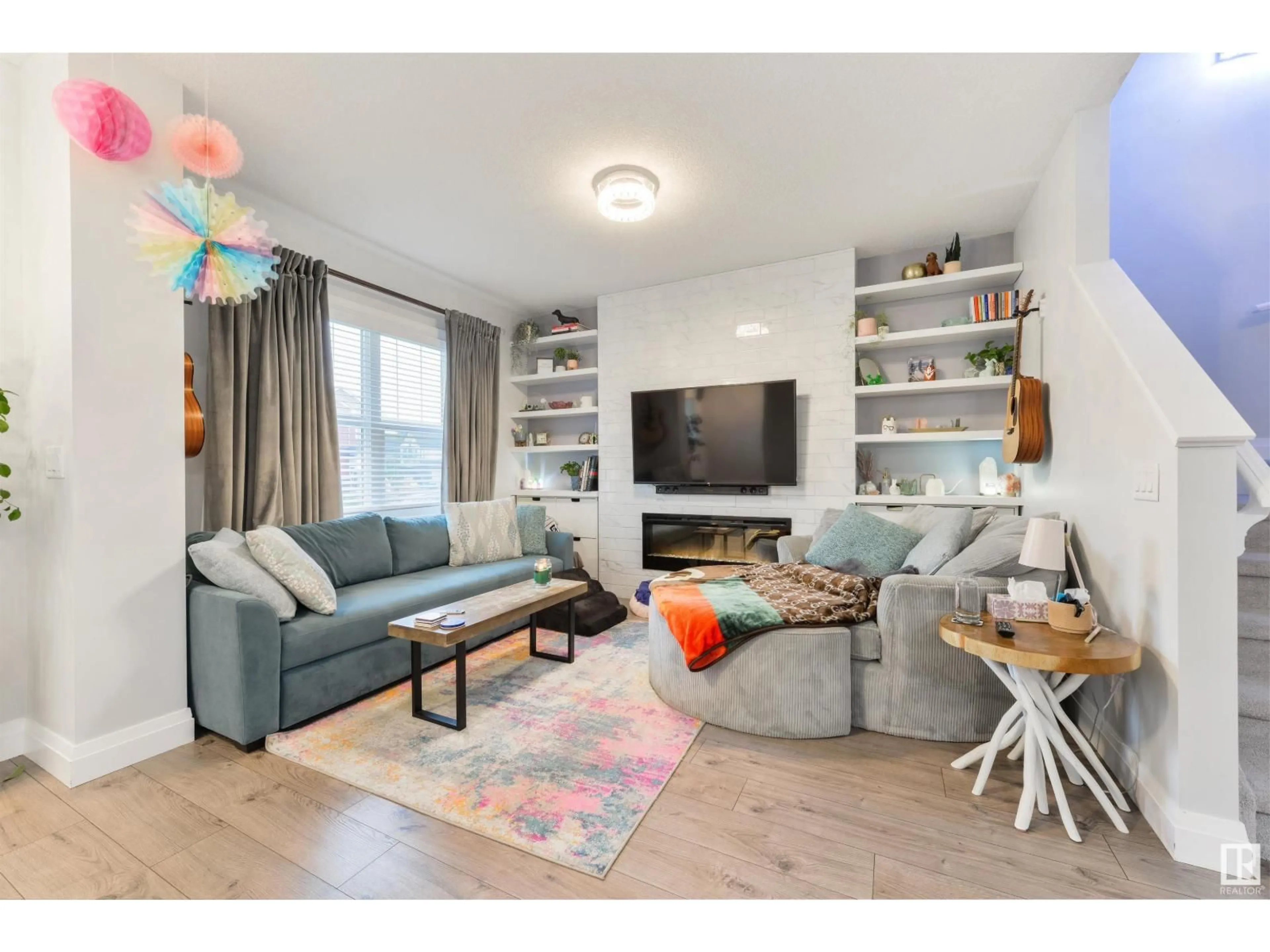 Living room with furniture, wood/laminate floor for 9820 106 AV, Morinville Alberta T8R2P1