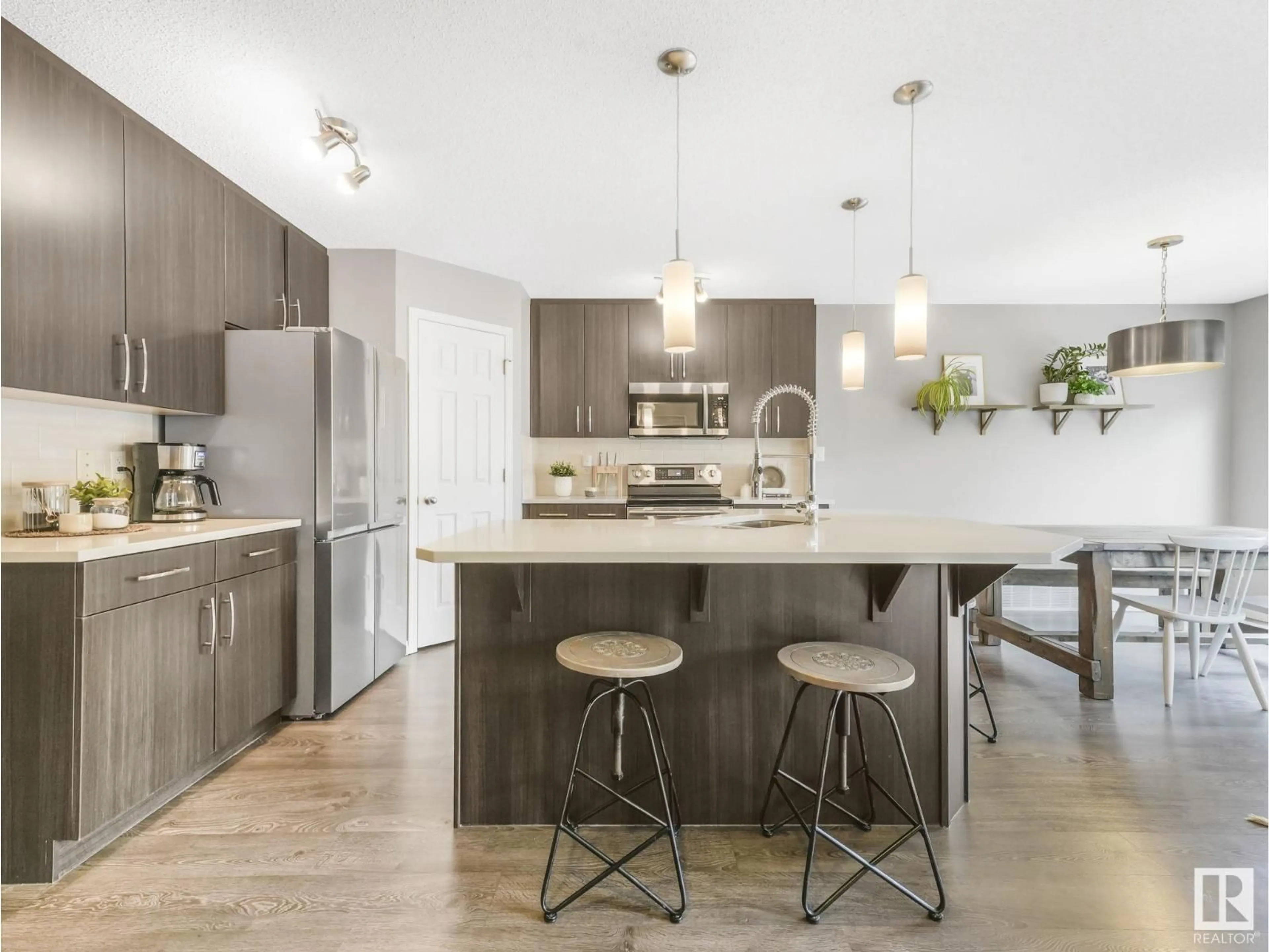 Open concept kitchen, wood/laminate floor for 1671 CHAPMAN WY, Edmonton Alberta T6W0Y5