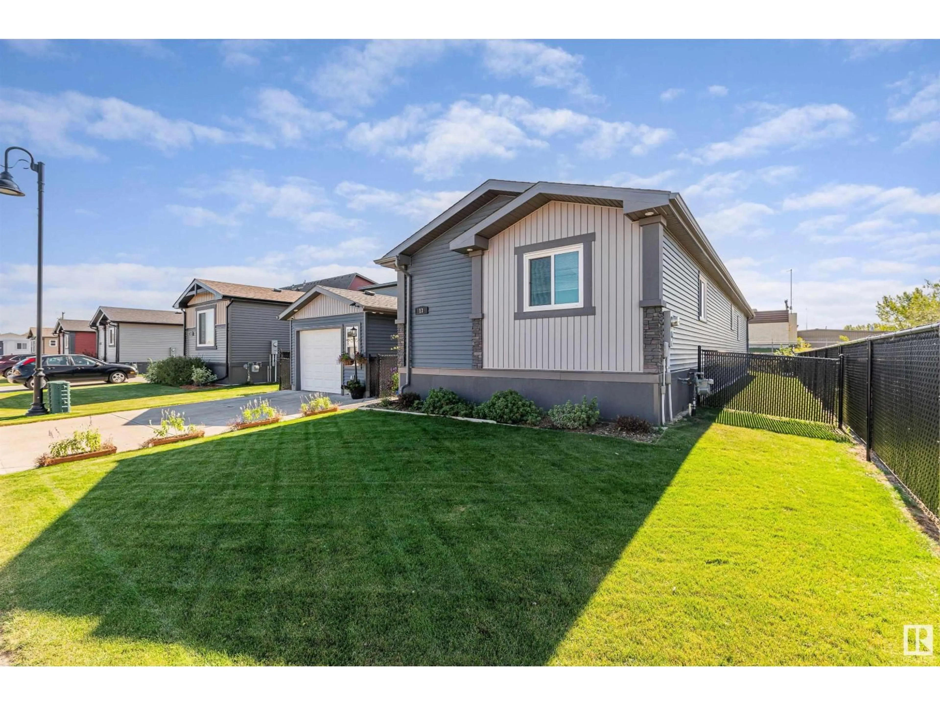 Home with vinyl exterior material, street for 13 LAUREL DR, Morinville Alberta T8R2P7
