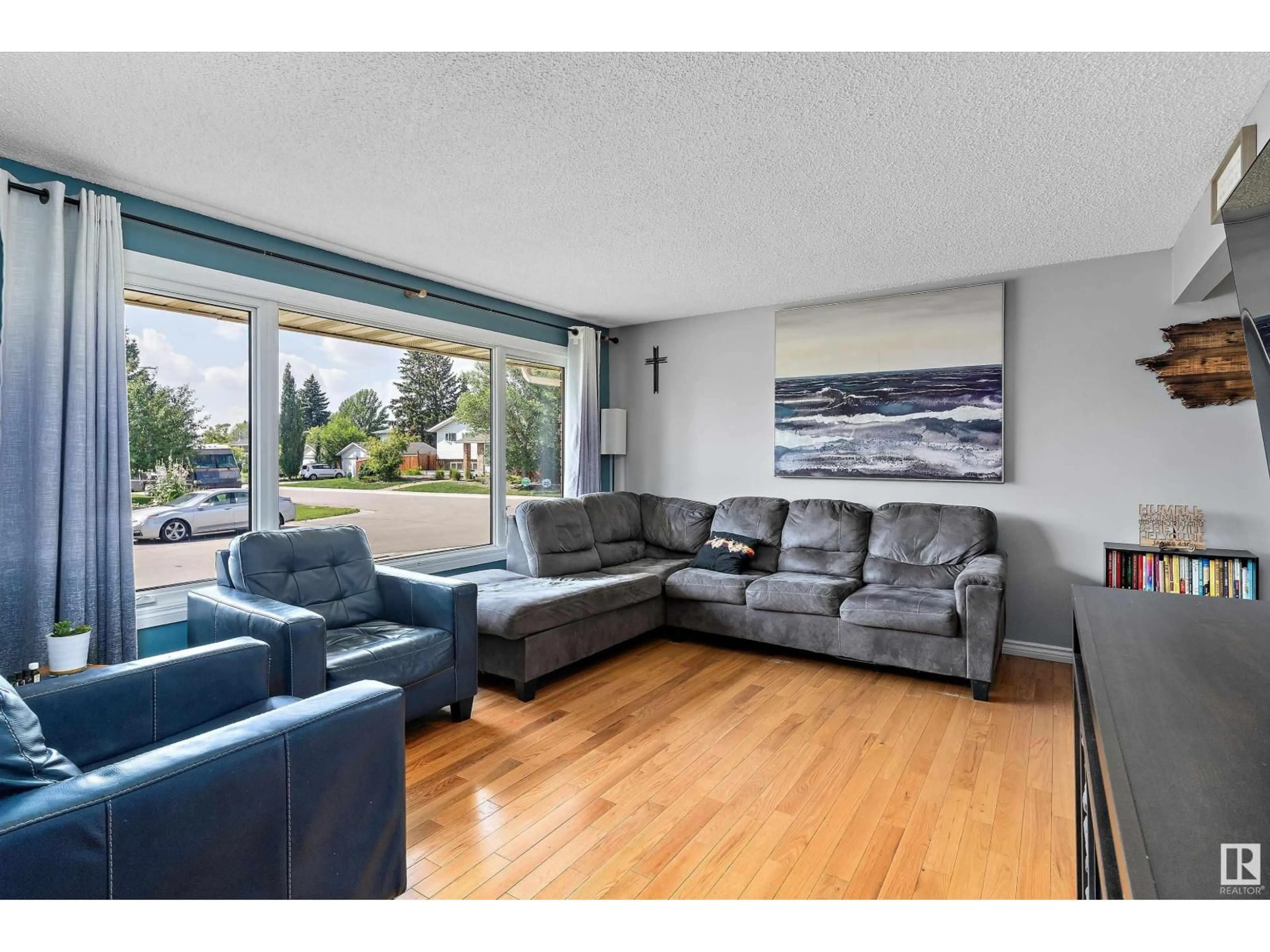 Living room with furniture, wood/laminate floor for 4219 86 ST, Edmonton Alberta T6K1E4