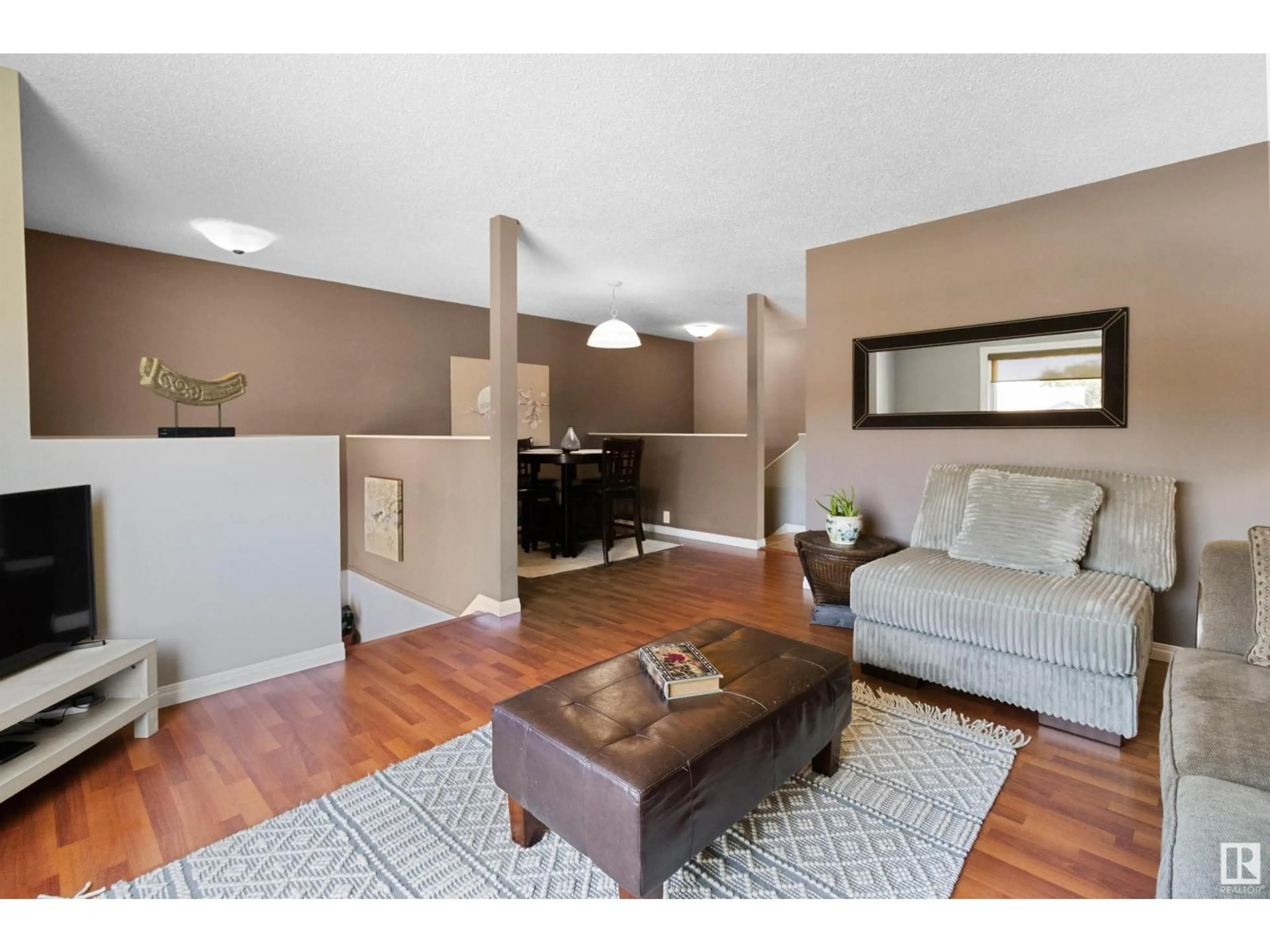 Living room with furniture, wood/laminate floor for 16 HOWSON CR, Edmonton Alberta T5A4V2
